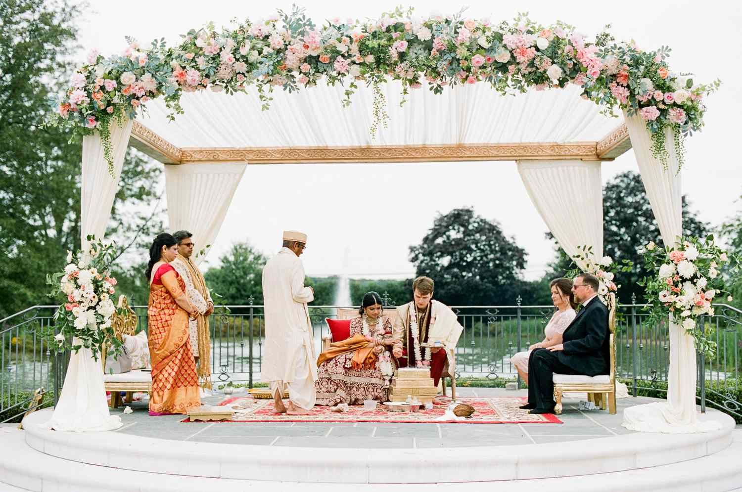 bride and groom and parents during indian wedding ceremony