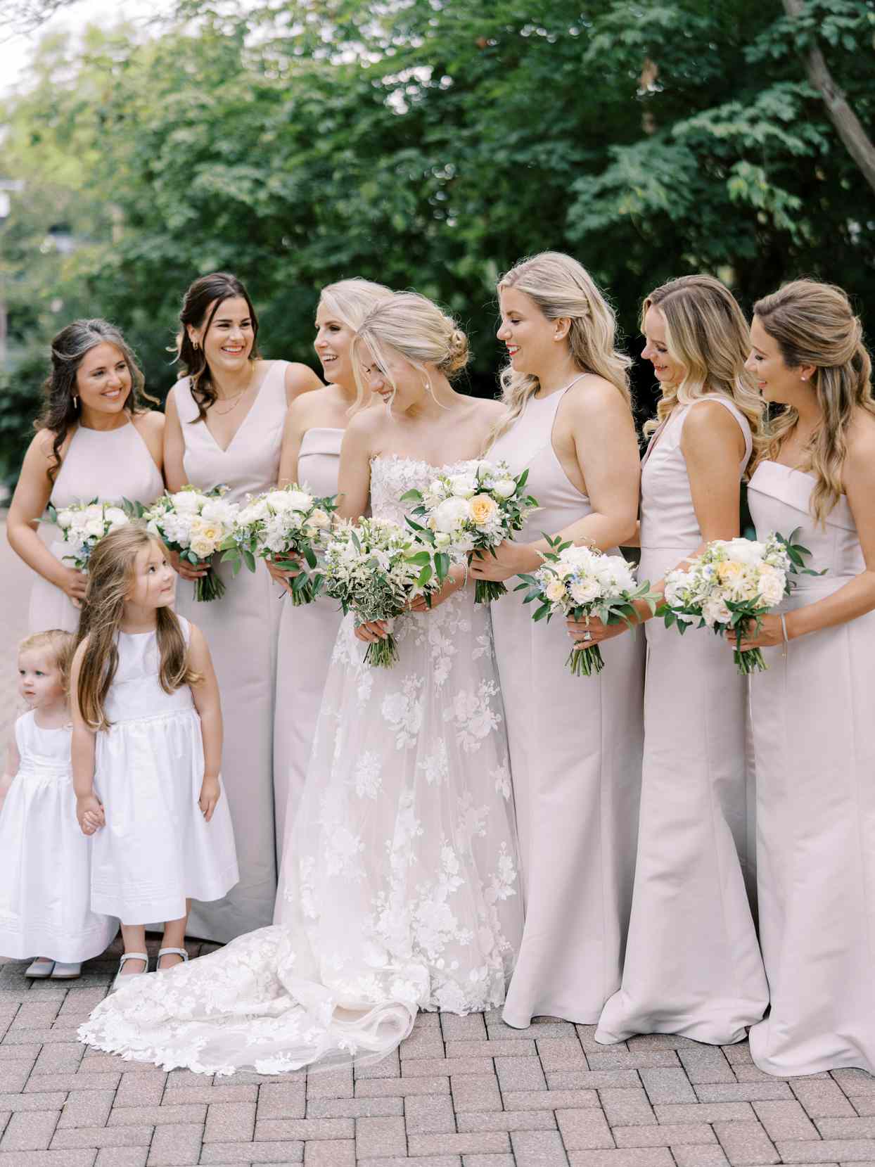 bride standing with six bridesmaids and two flower girls