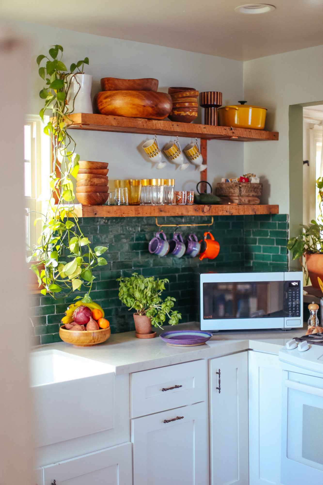 small kitchen with bold green tile backsplash