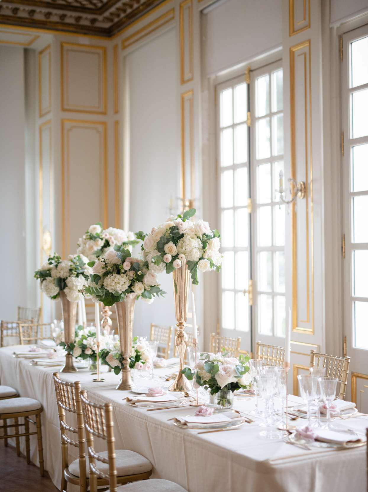 french chateau wedding reception setup with gold and white elements