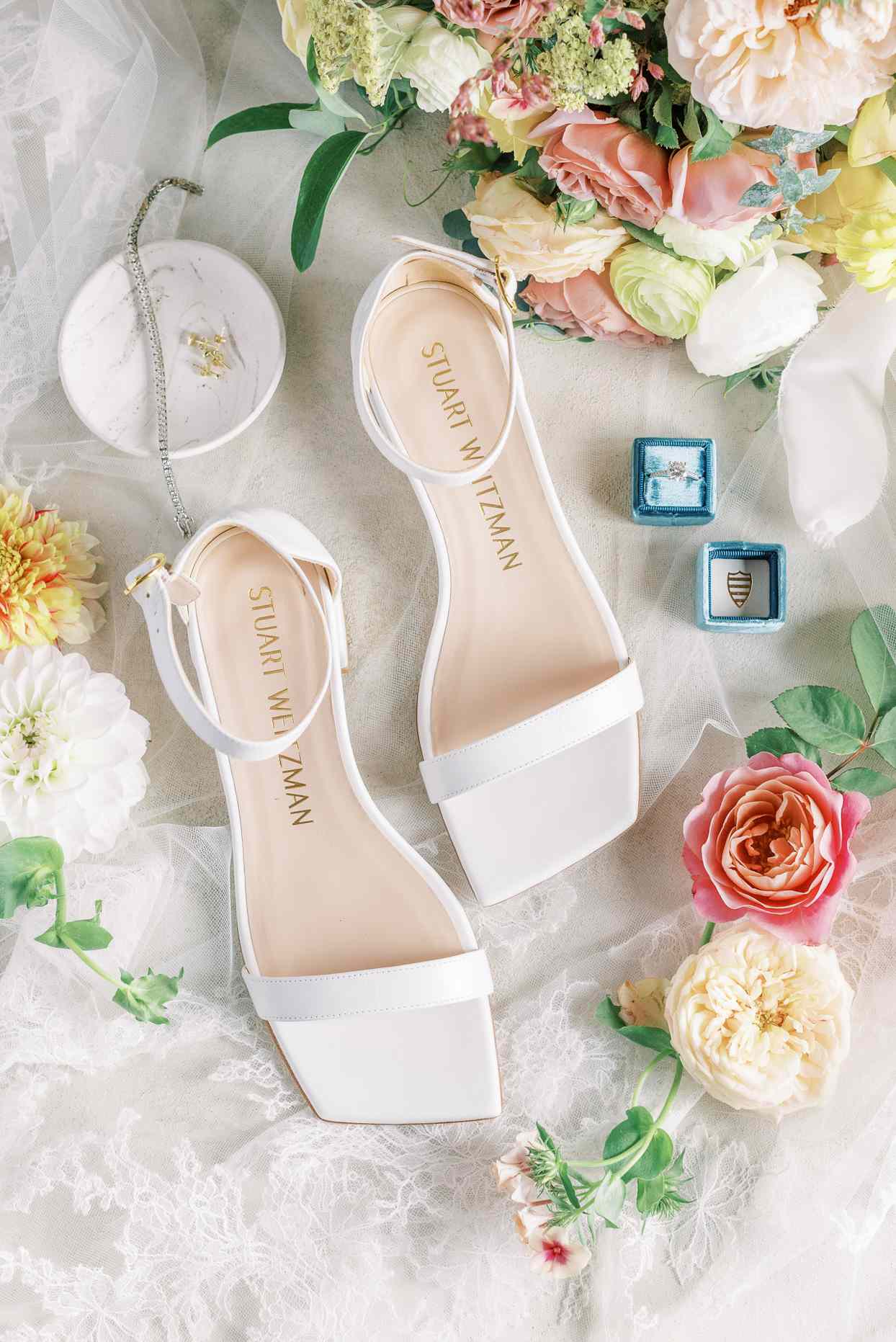 bride's white wedding shoes, flowers, and ring