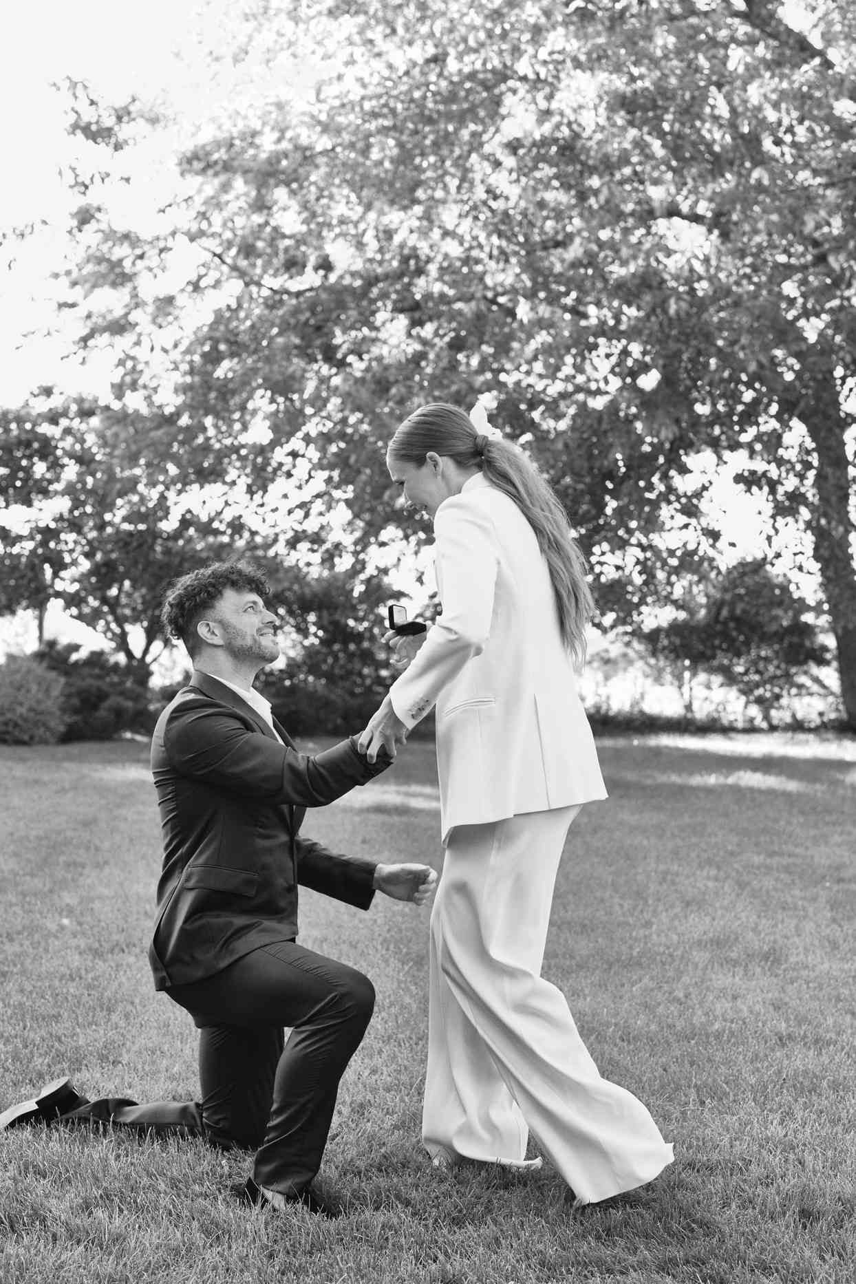 man kneeling proposing to woman