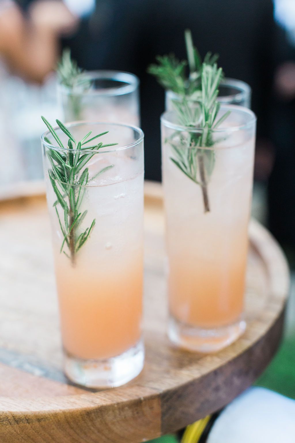 pale pink wedding cocktails with rosemary sprig