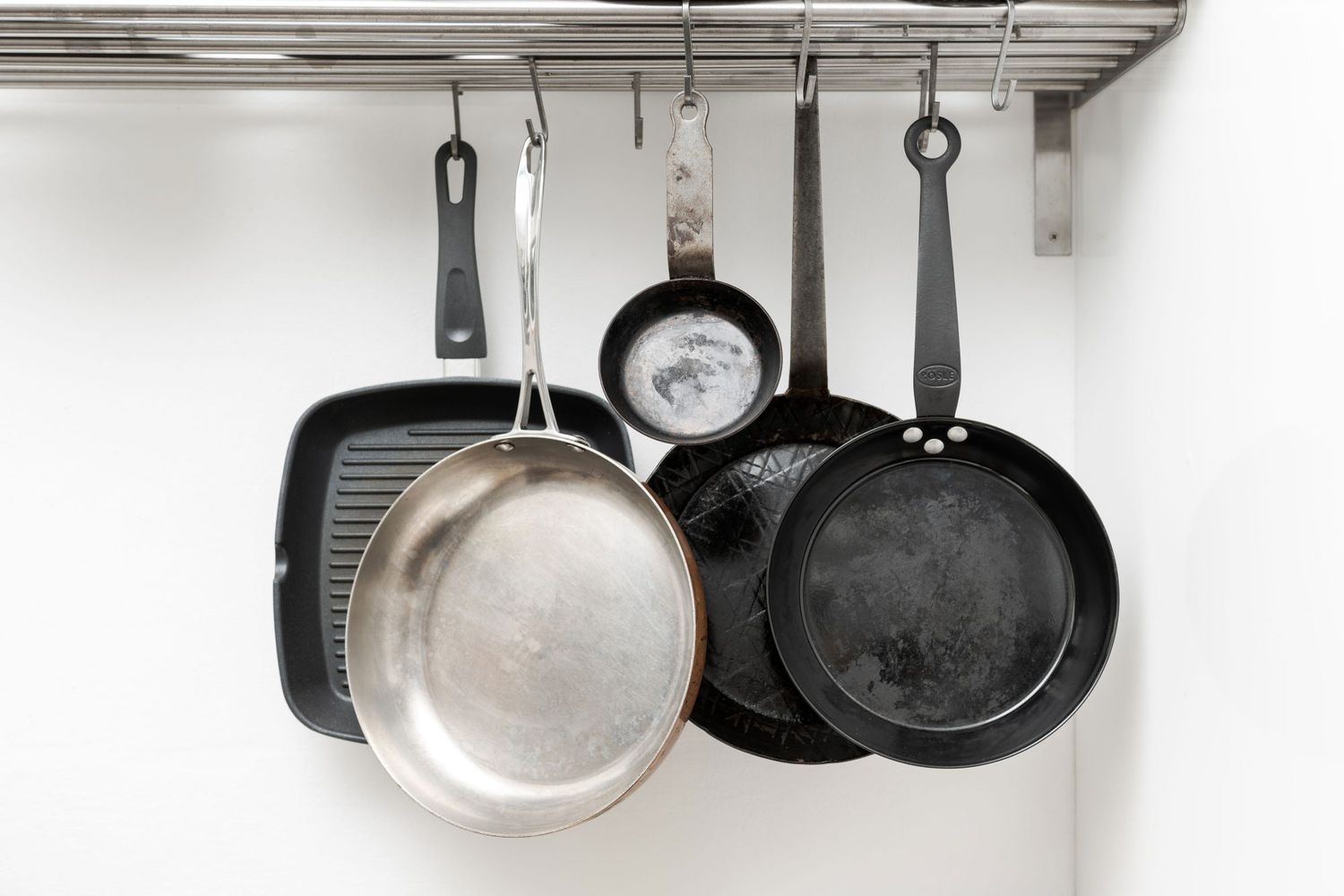 various cooking pan styles on hanging rack
