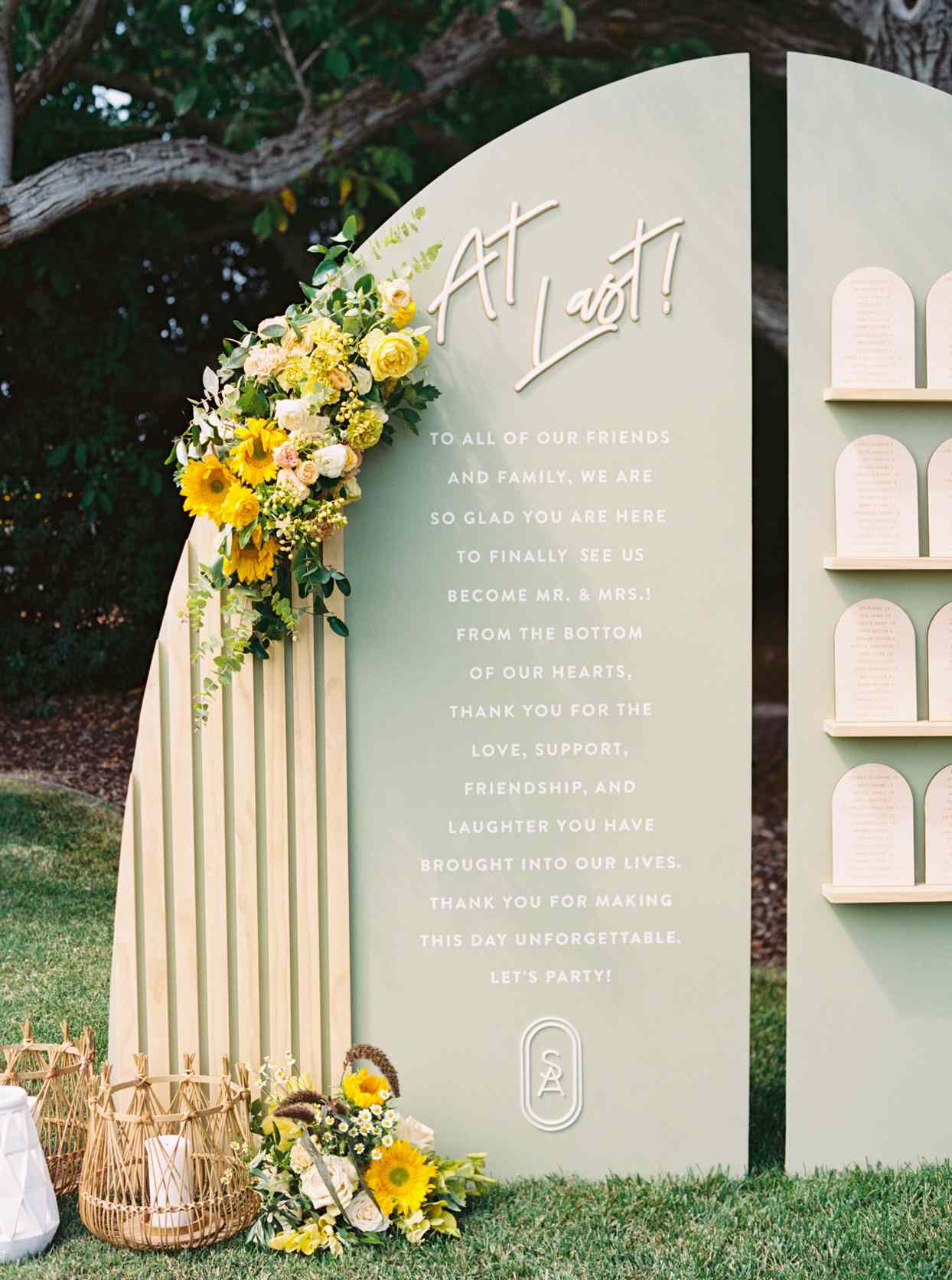 curved escort card display with yellow flowers
