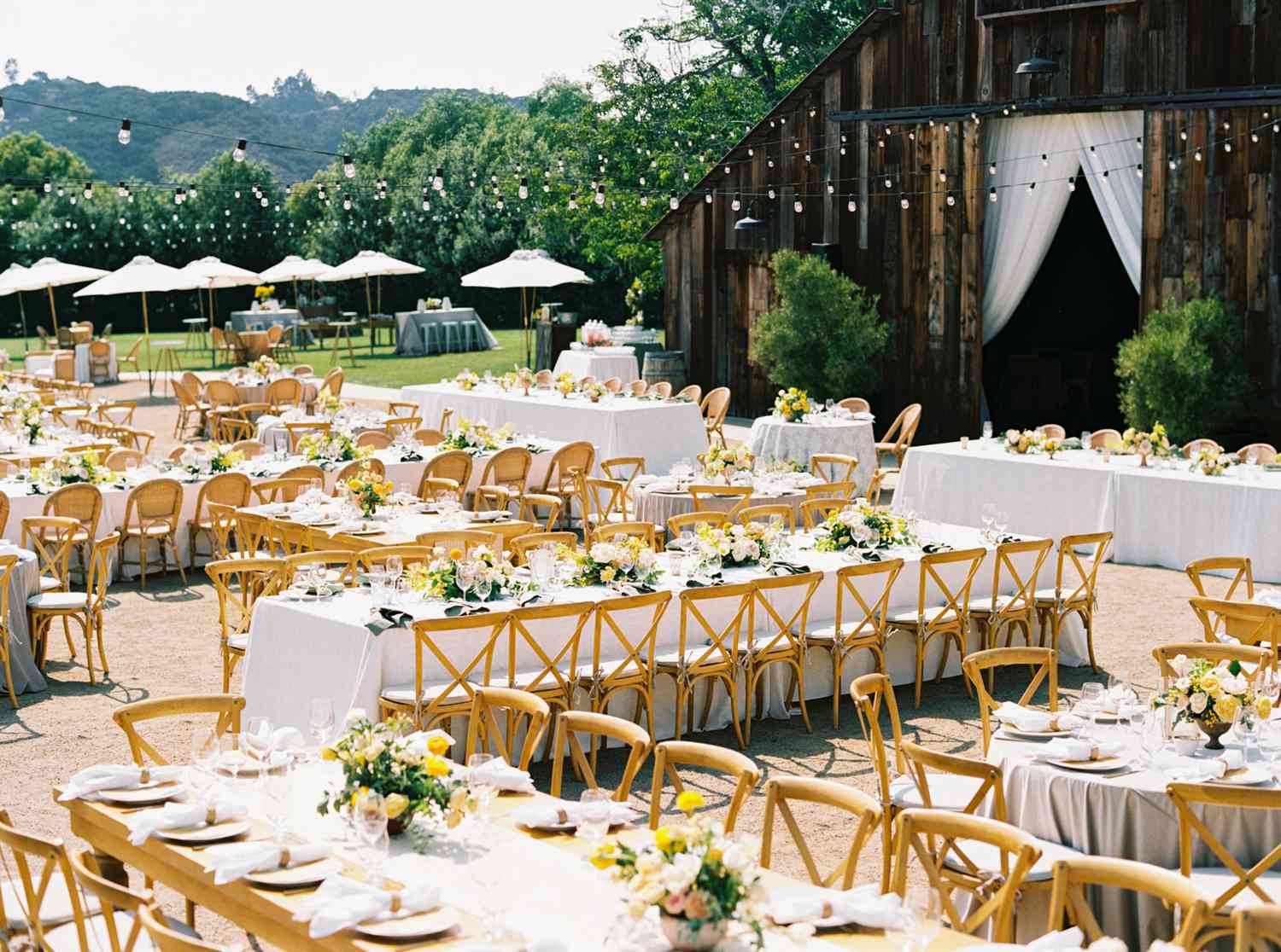 wedding reception long tables outside barn