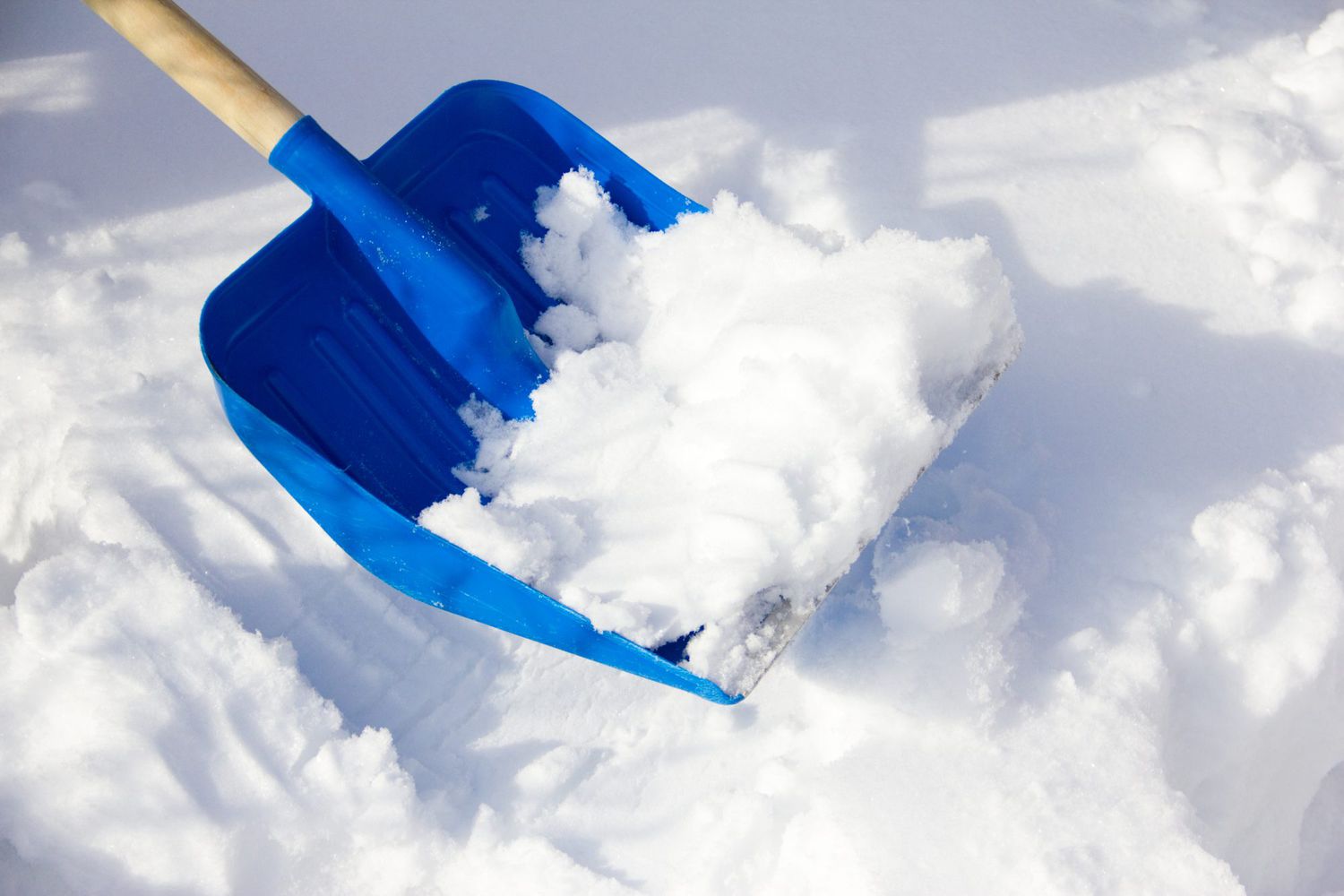 shoveling snow blue shovel