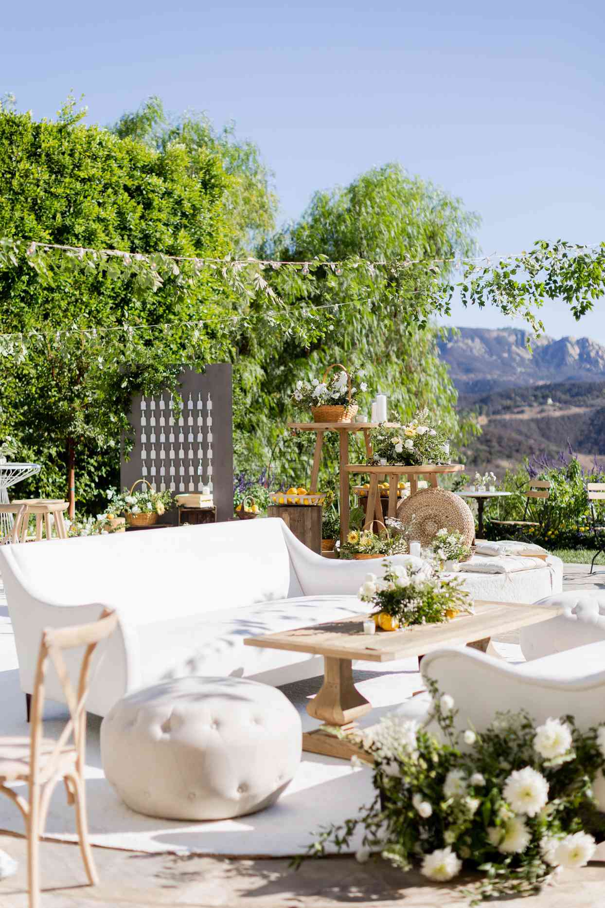 engagement party with white outdoor furniture overlooking mountains