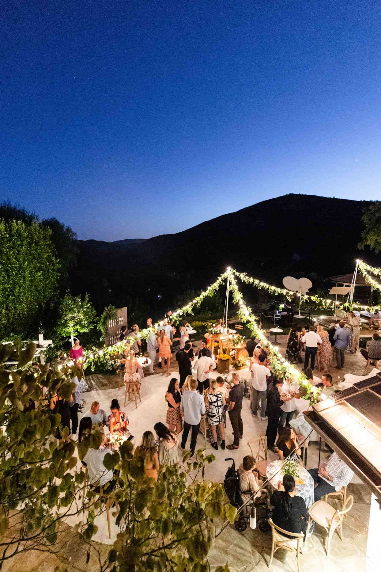 outdoor engagement party with string lights overlooking the mountains
