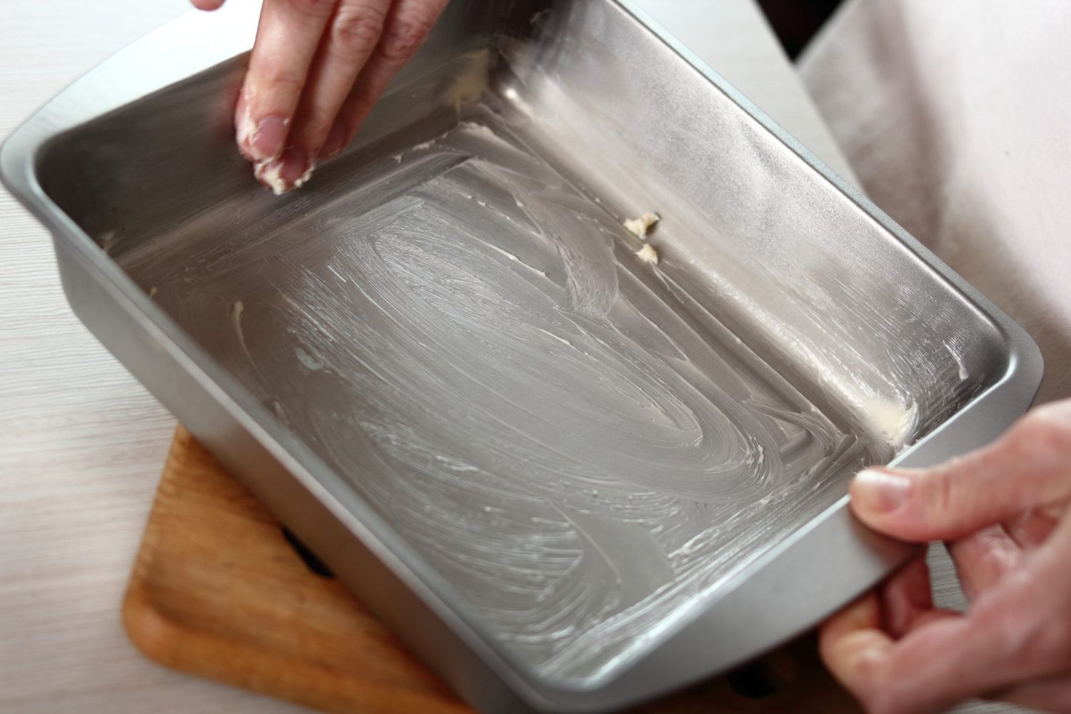 Greasing baking pan with fingers