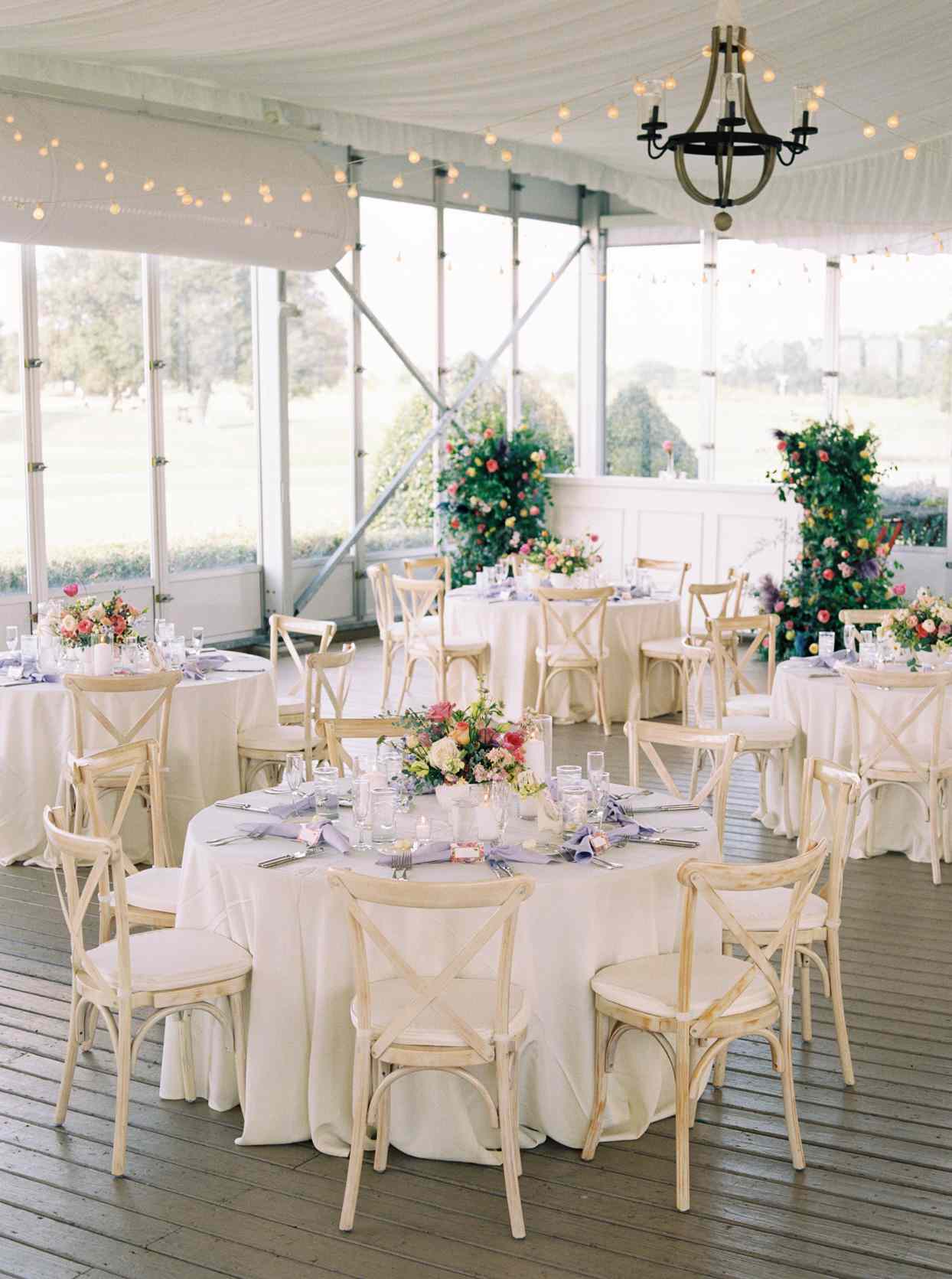 wedding reception setup in room with large windows