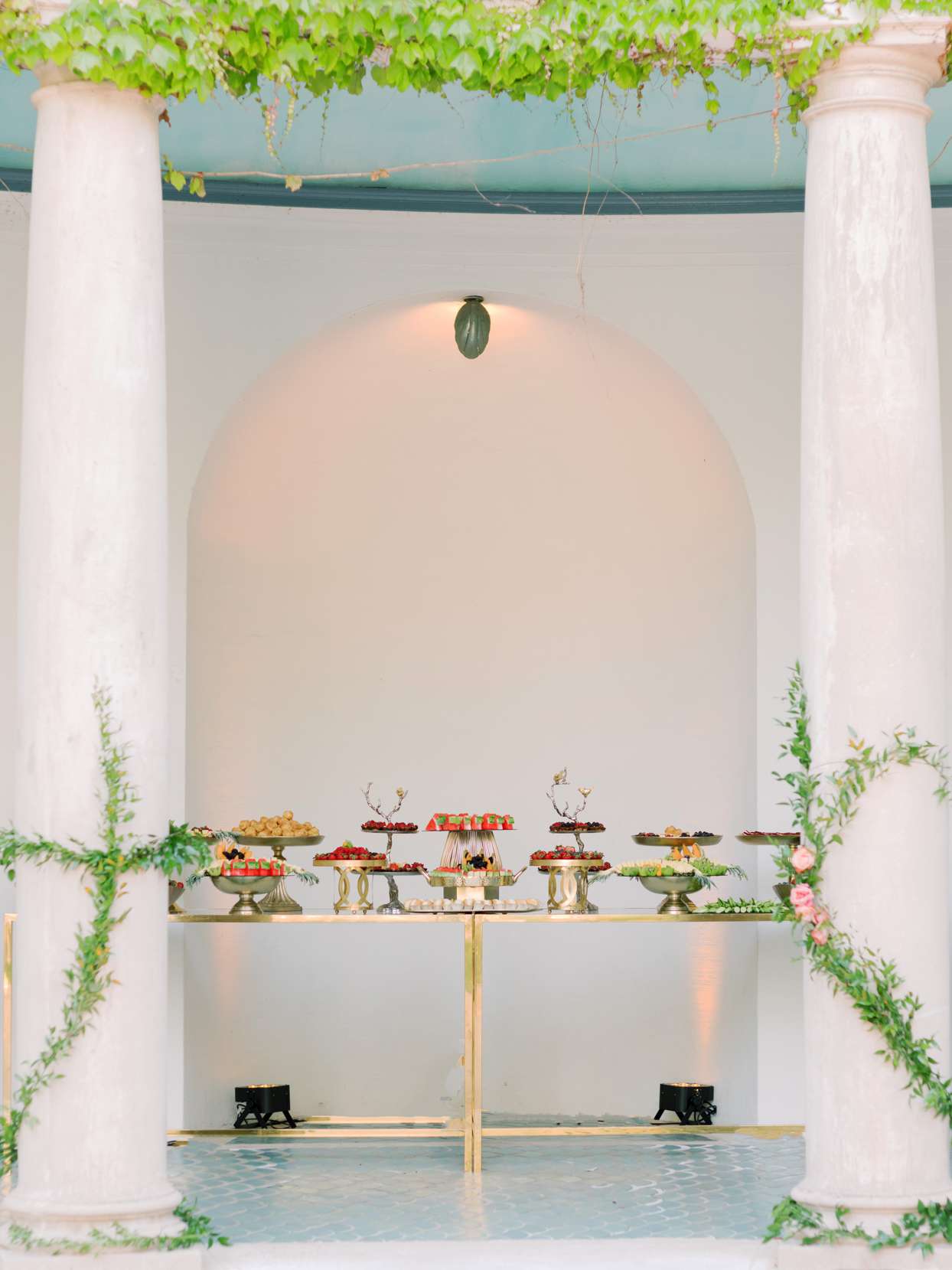 gold trimmed tables topped with various foods
