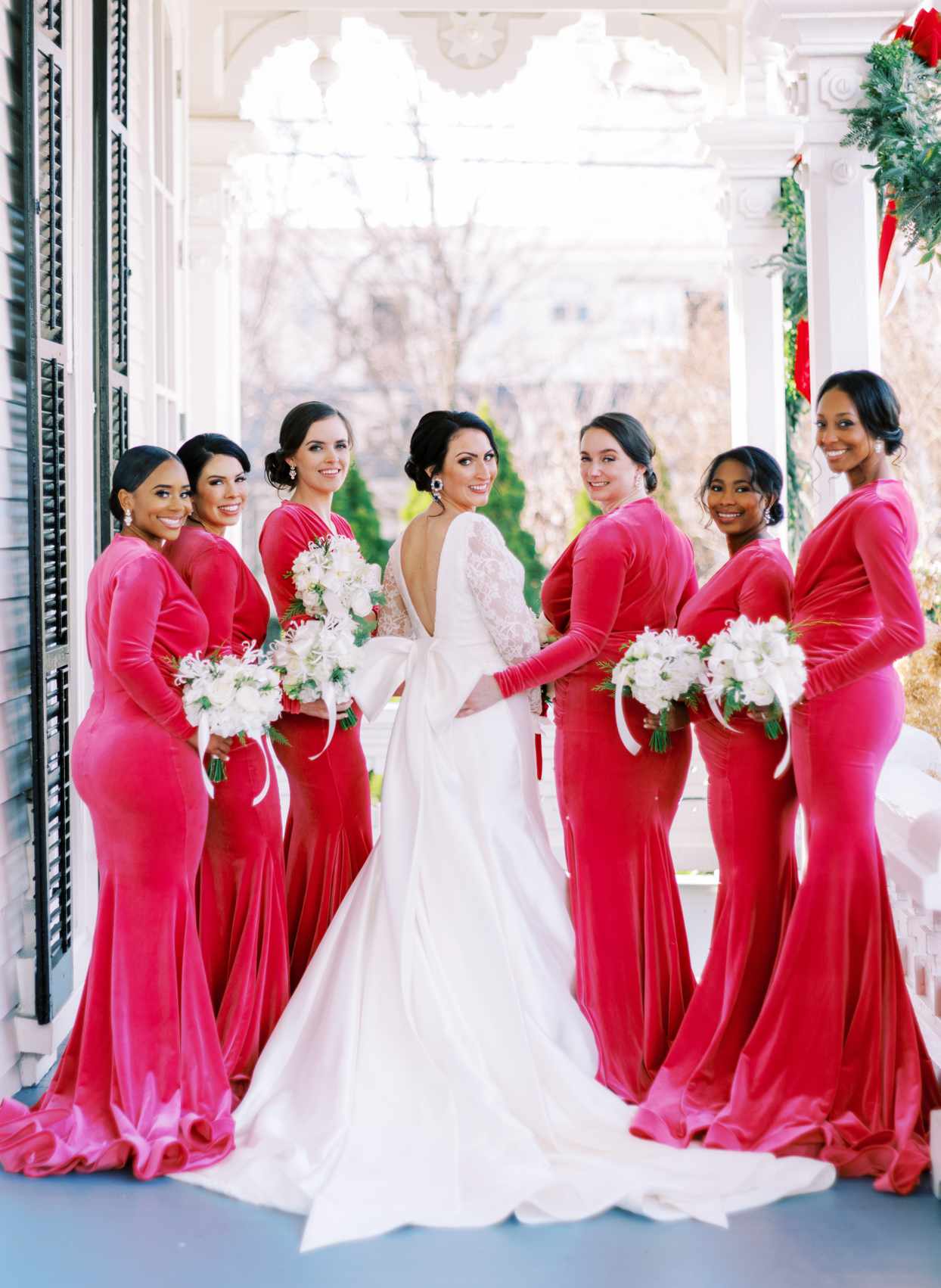 bride with bridesmaids wearing pink velvet gowns