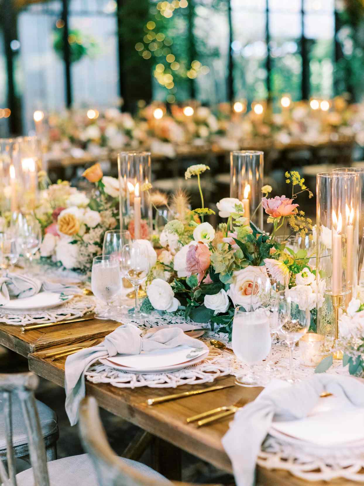 wooden long tables with elegant flowers and candle decor