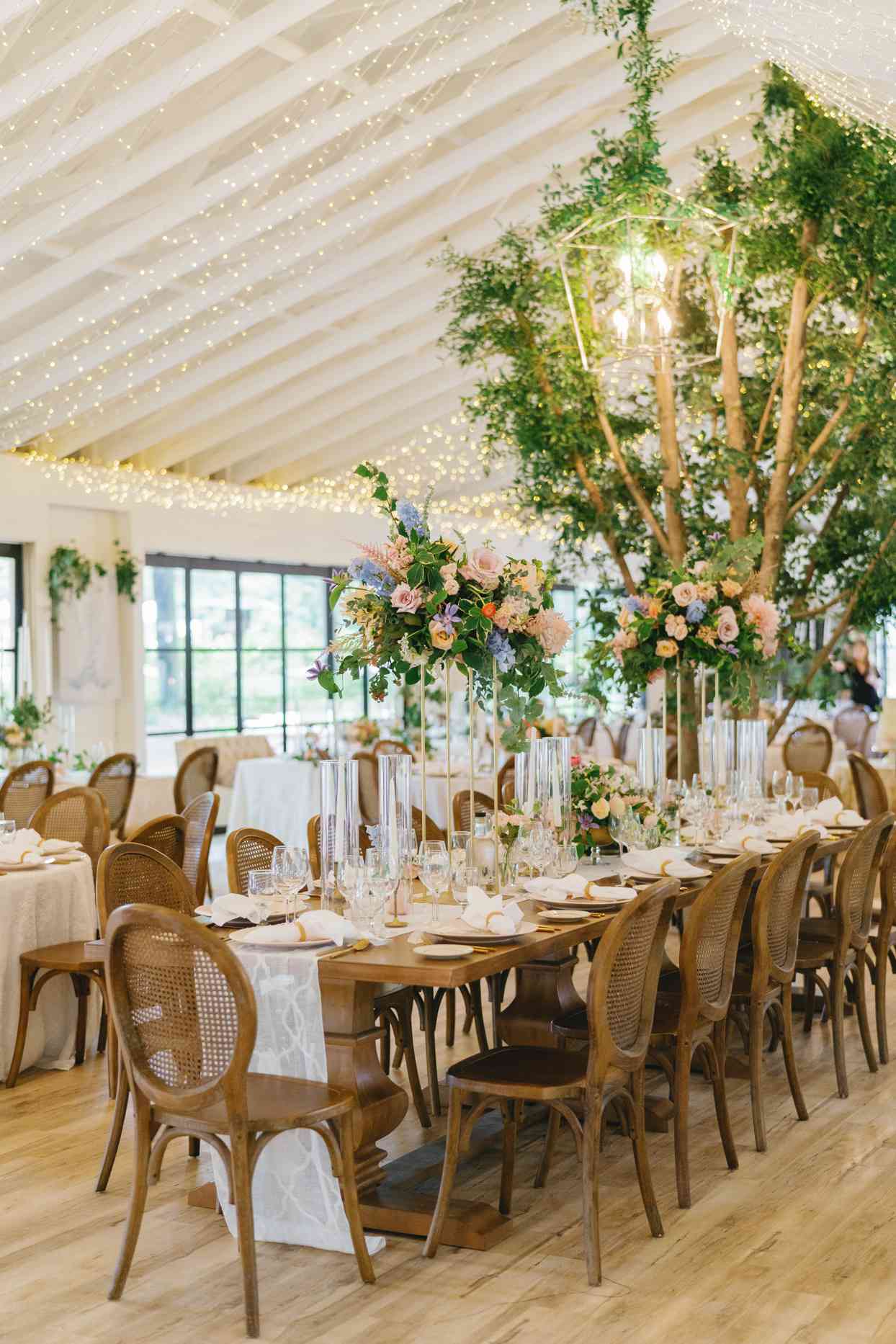 wedding reception room with wooden tables and chairs