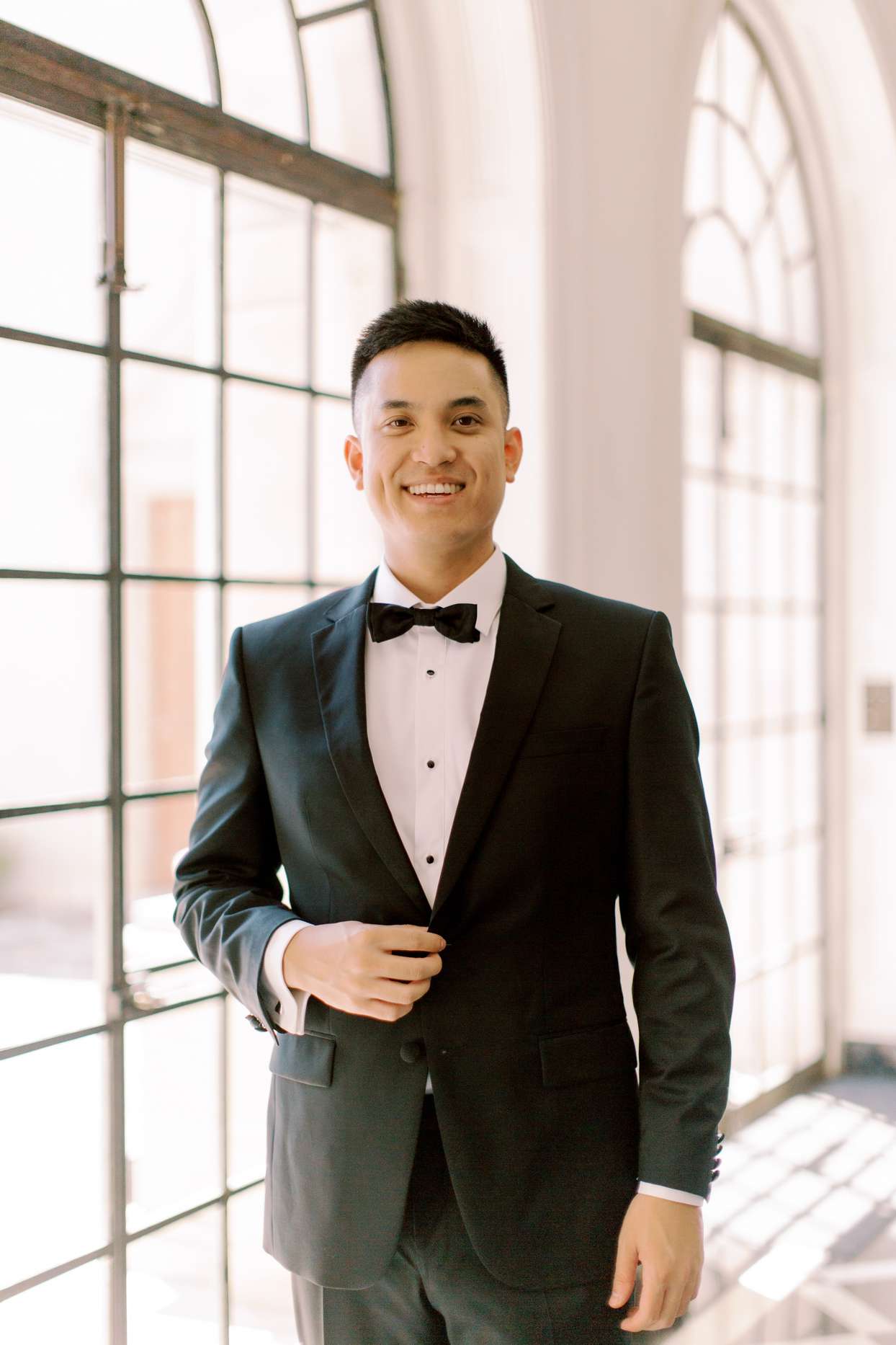 groom wearing classic black tux with bowtie