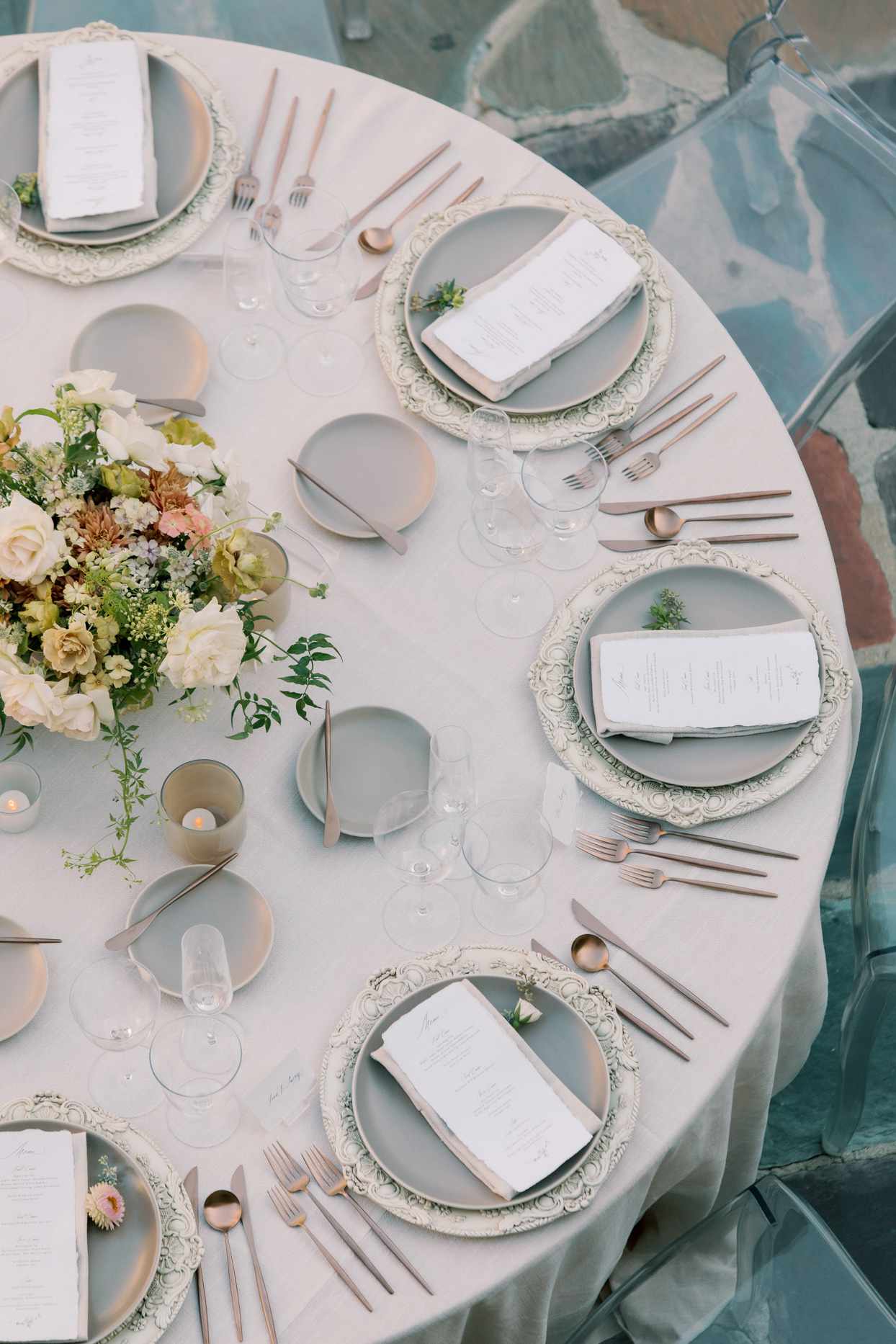 round reception tables with neutral toned placesettings