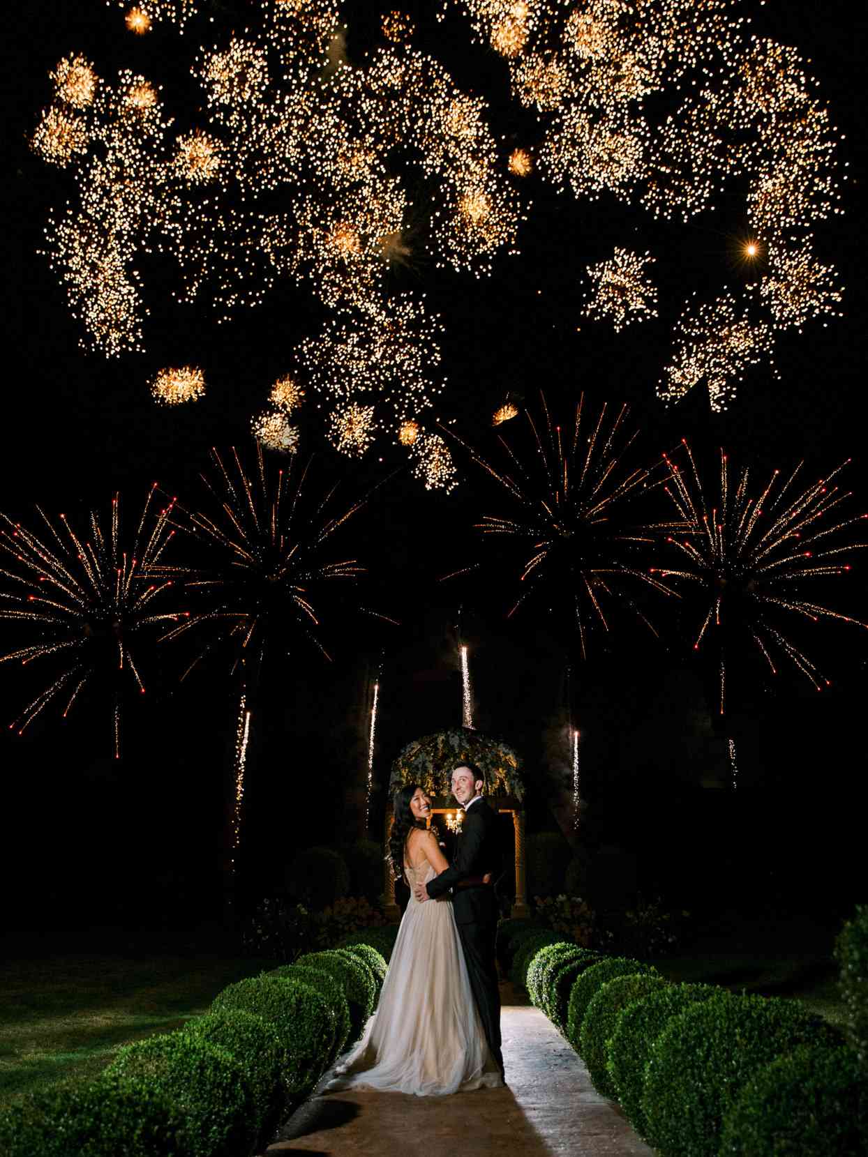 couple under fireworks in night sky