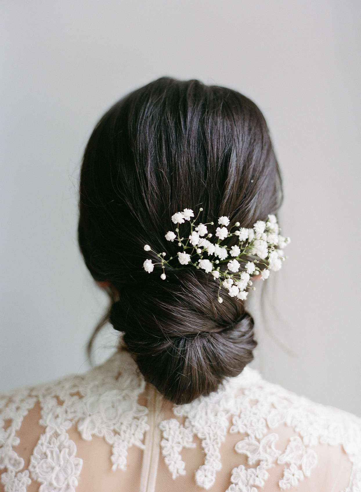 bride's hair in twist bun with flowers