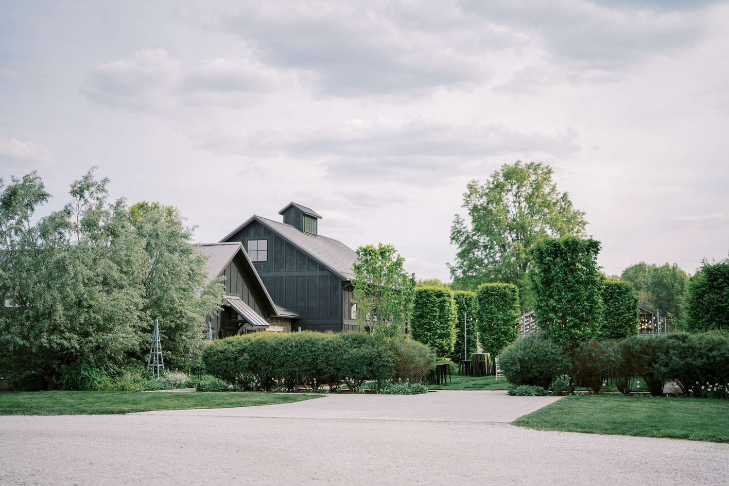 wedding venue exterior with tall hedges and trees