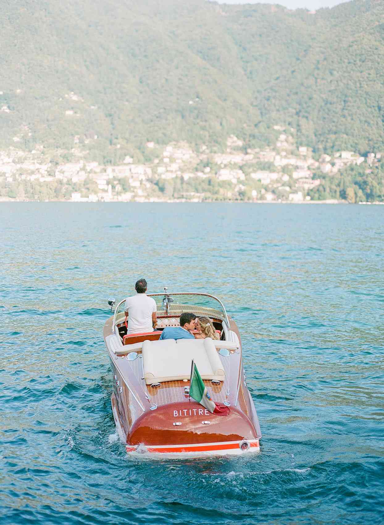 wedding couple kissing on boat ride