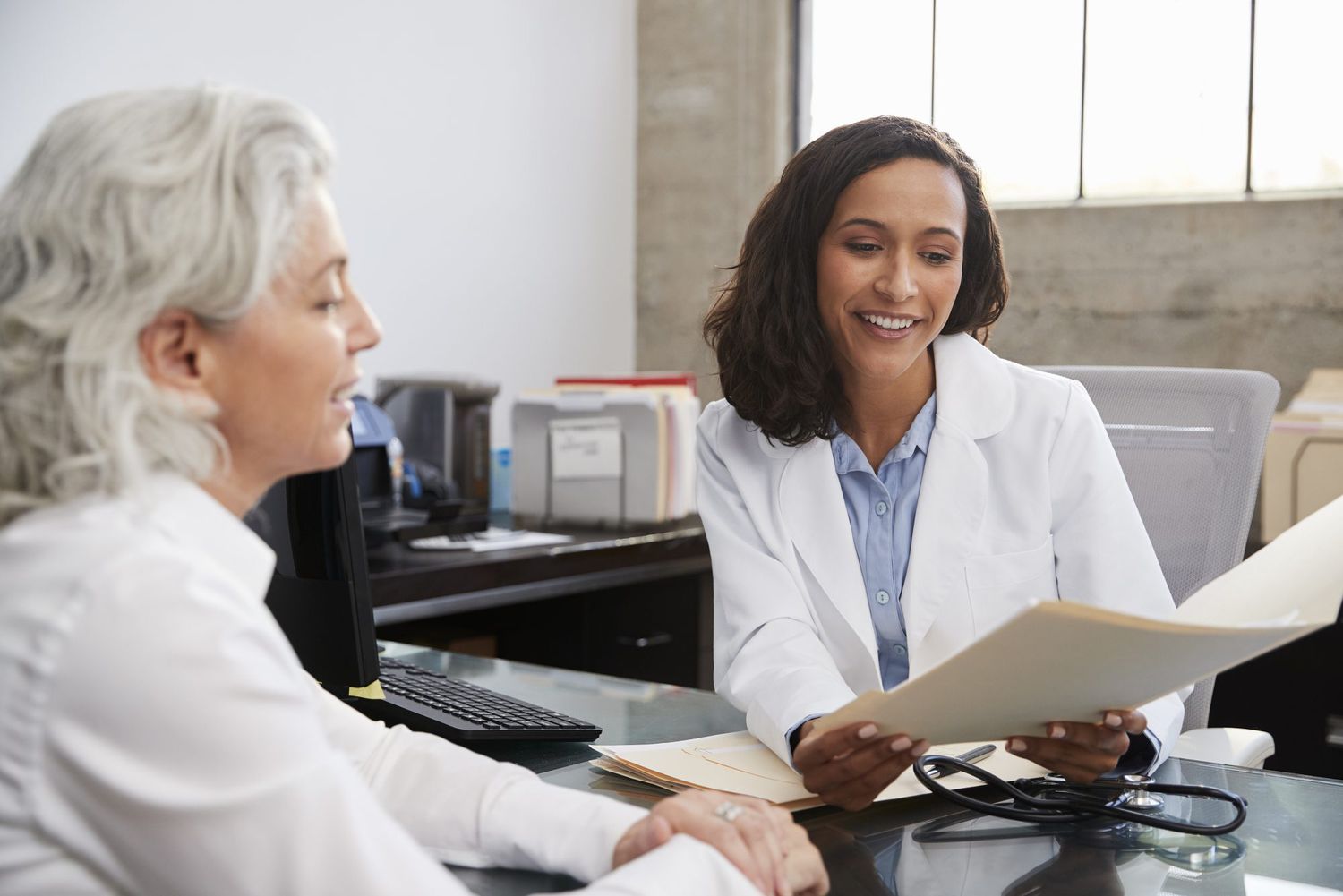 physician speaking with patient in office