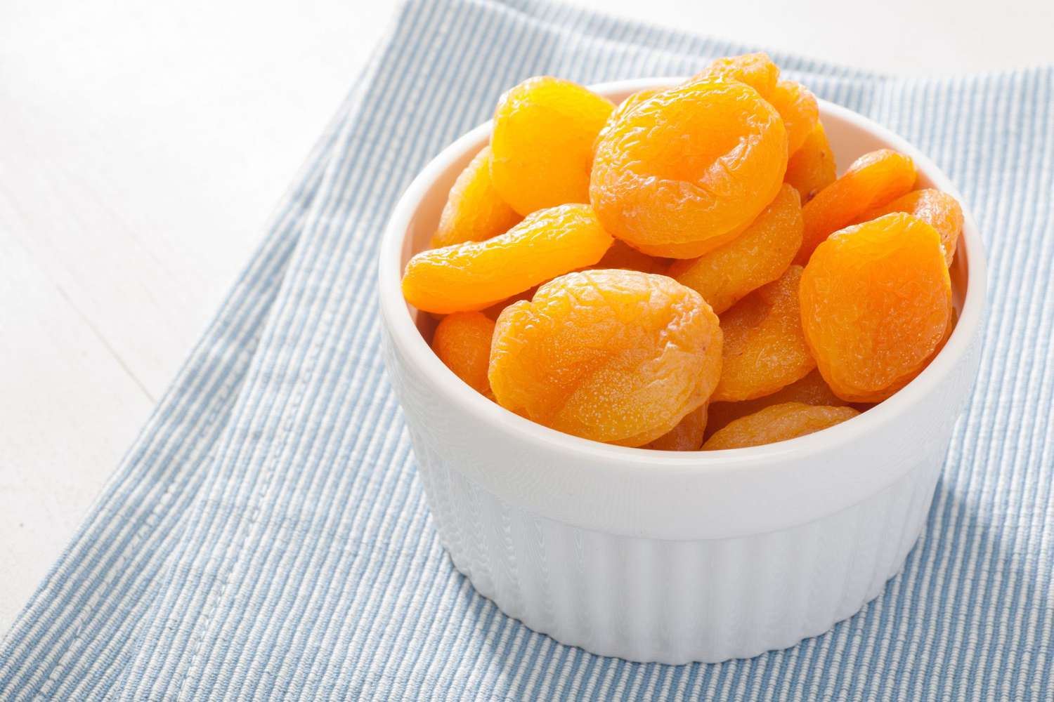 dried apricots in white bowl