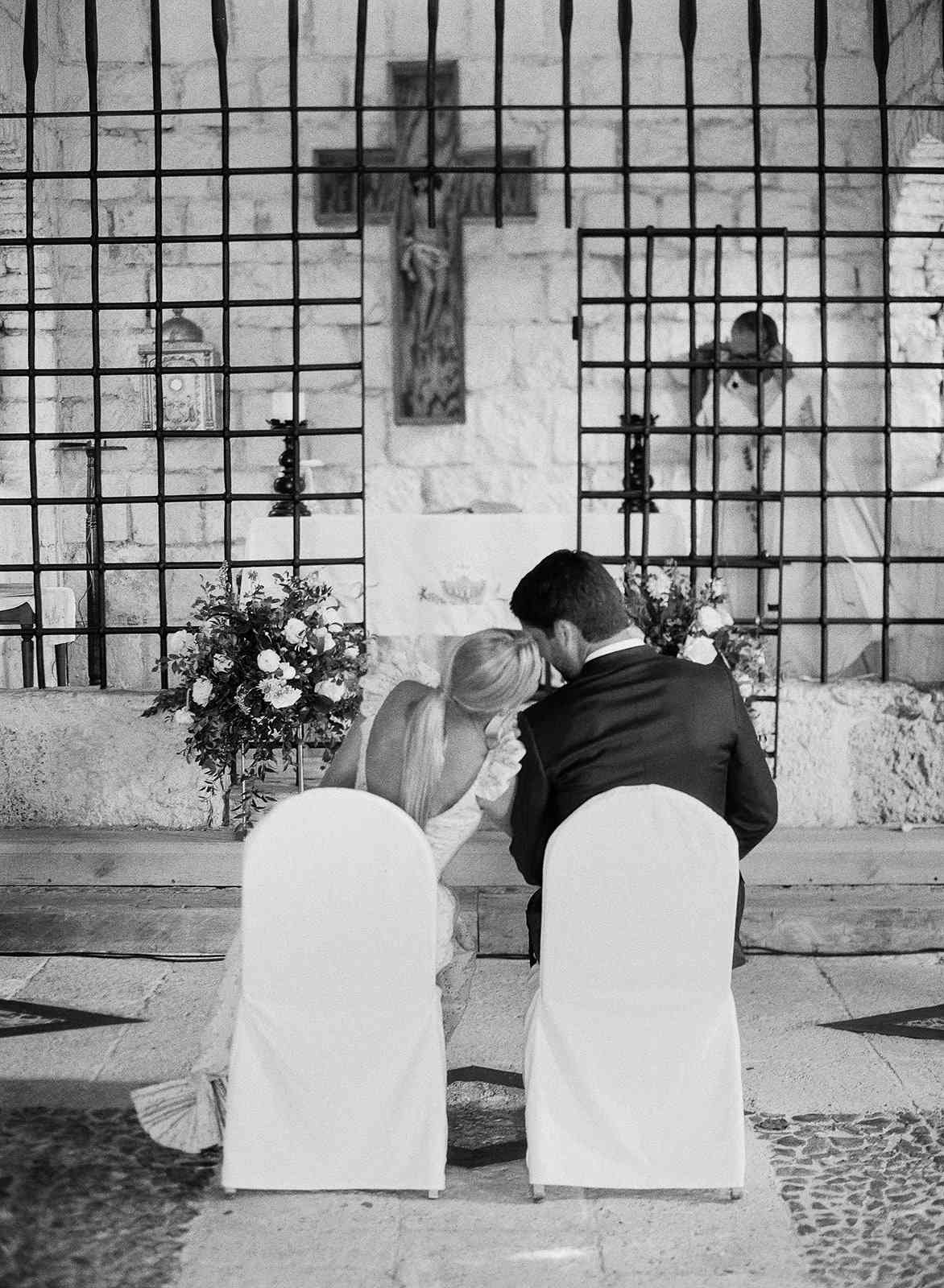 bride and groom seated in church