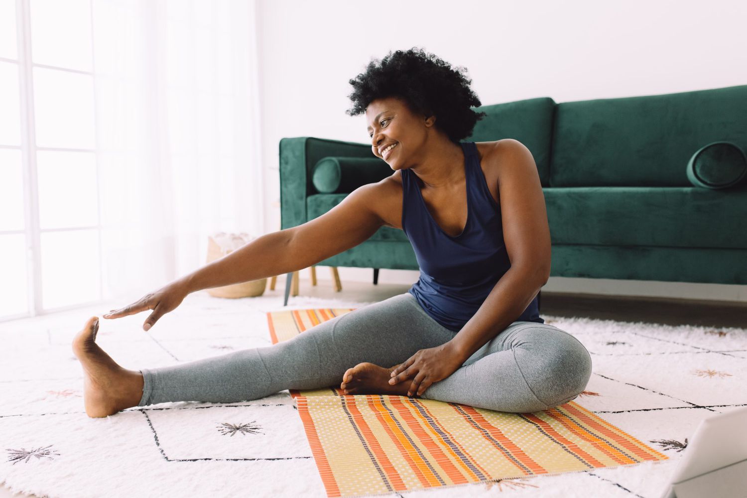 woman stretching on floor at home