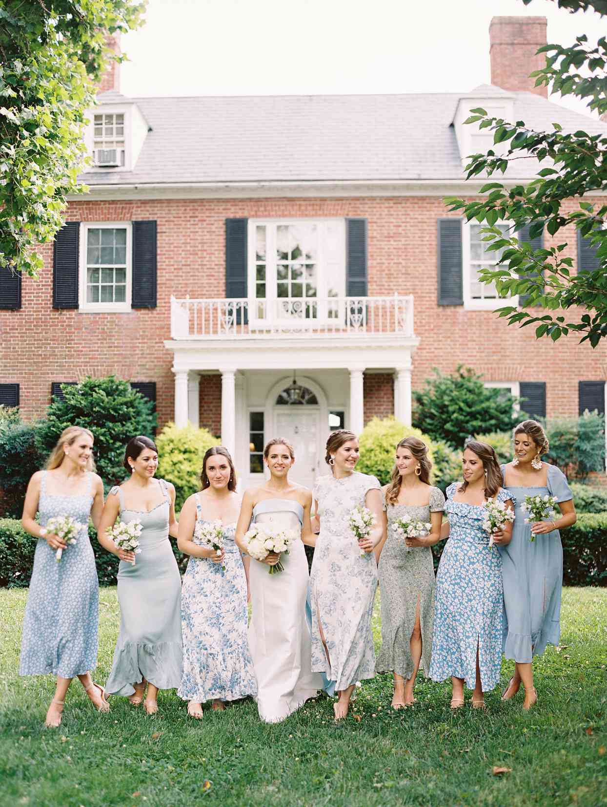 bride with bridesmaids in mismatched blue dresses