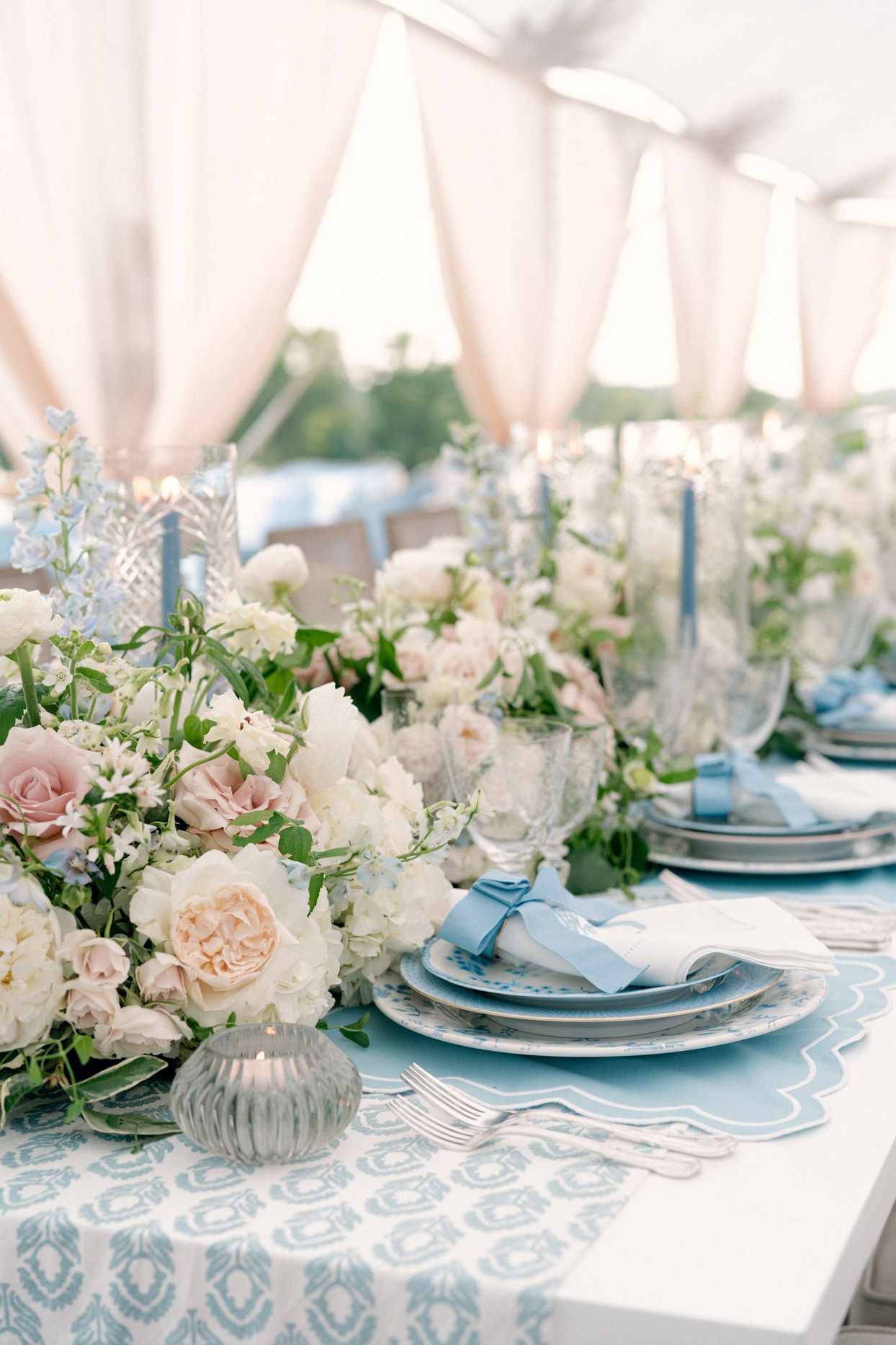 reception table with blue printed table runner and blush flowers
