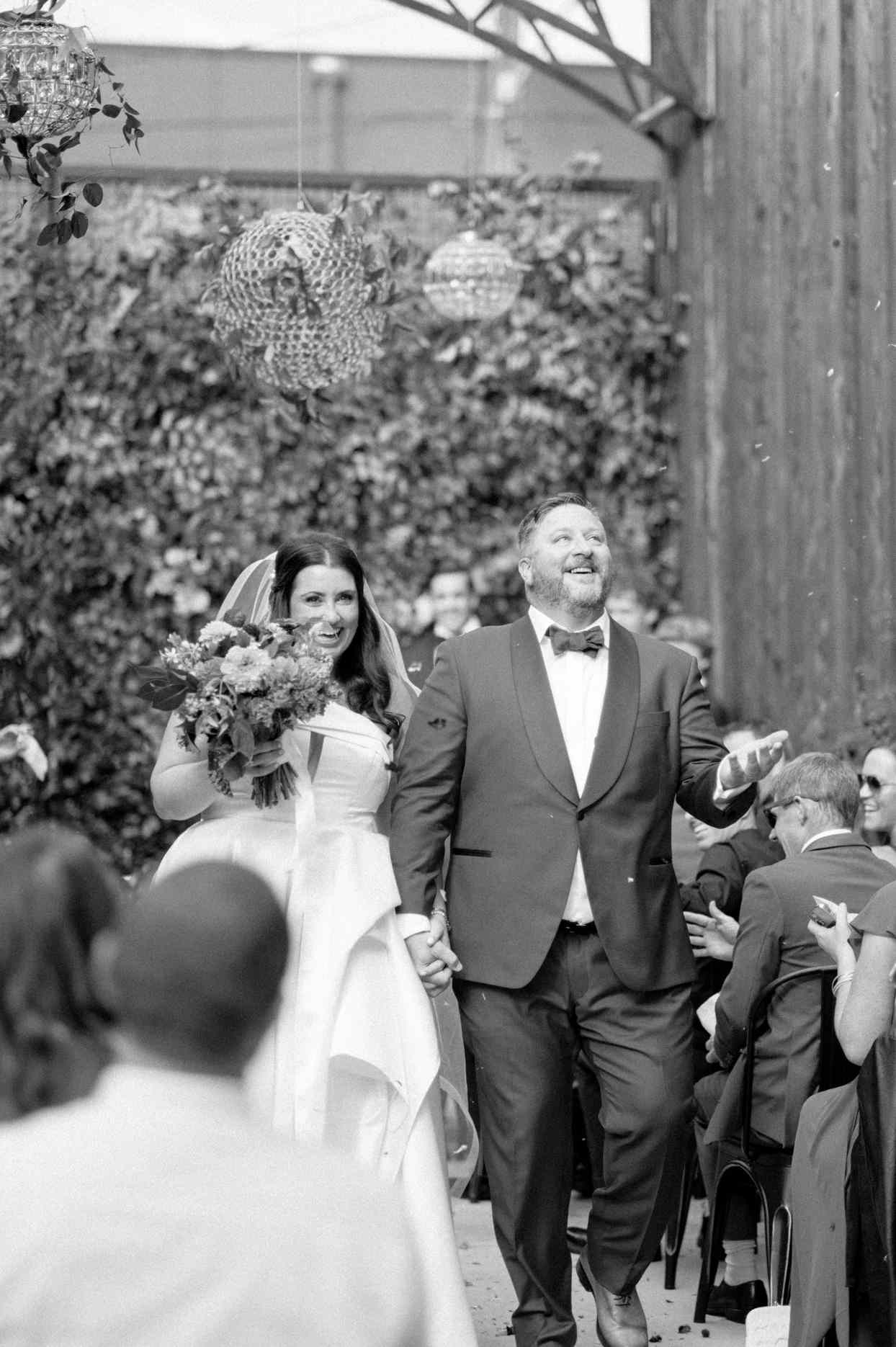 bride and groom walking during recessional after ceremony
