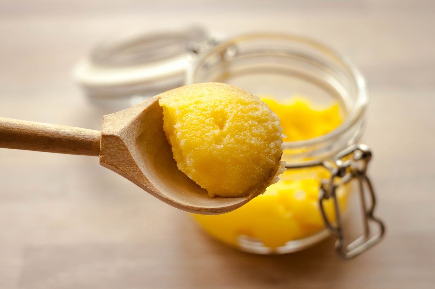 Clarified butter on wooden spoon