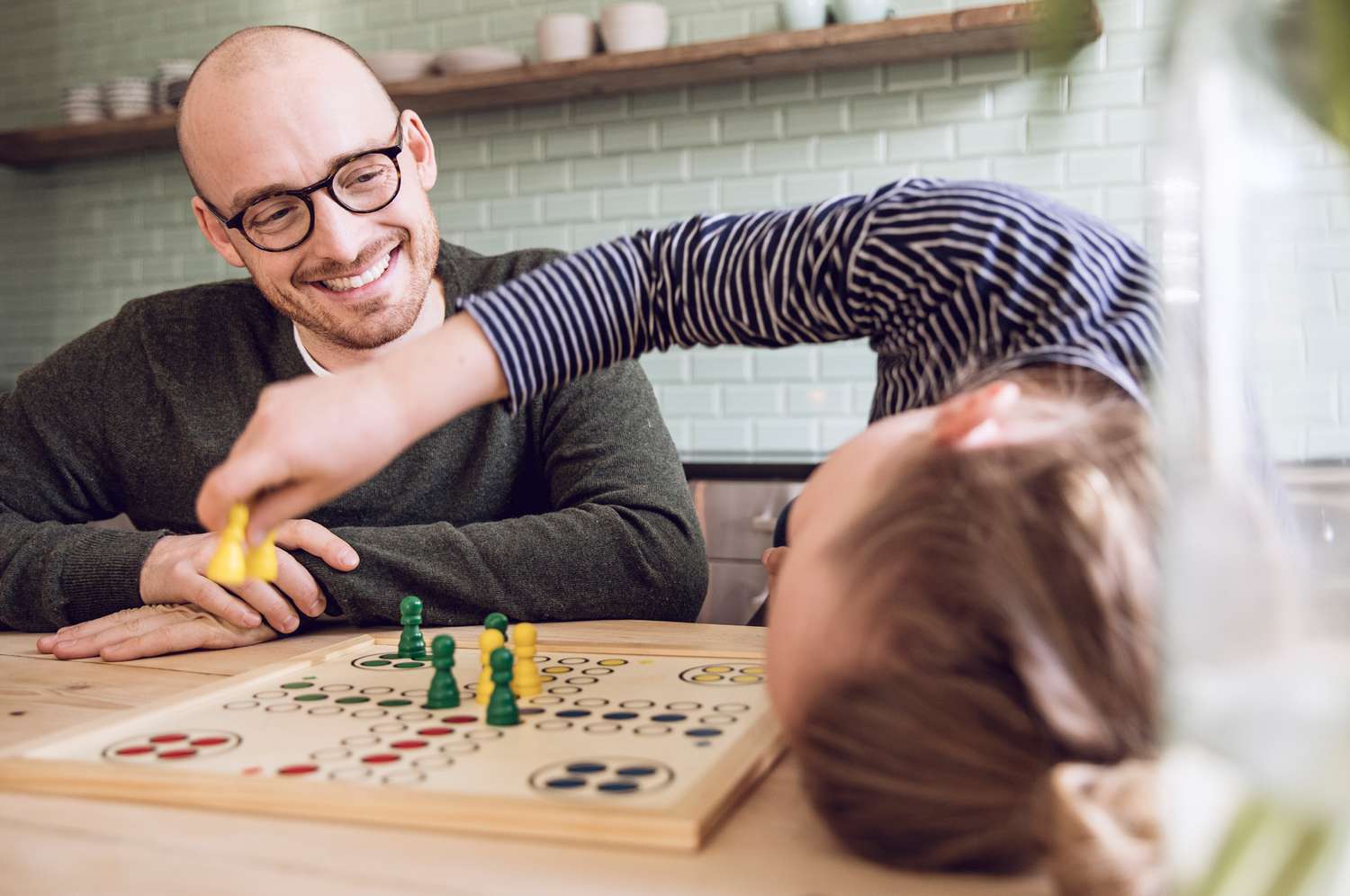 Dad playing board games with child
