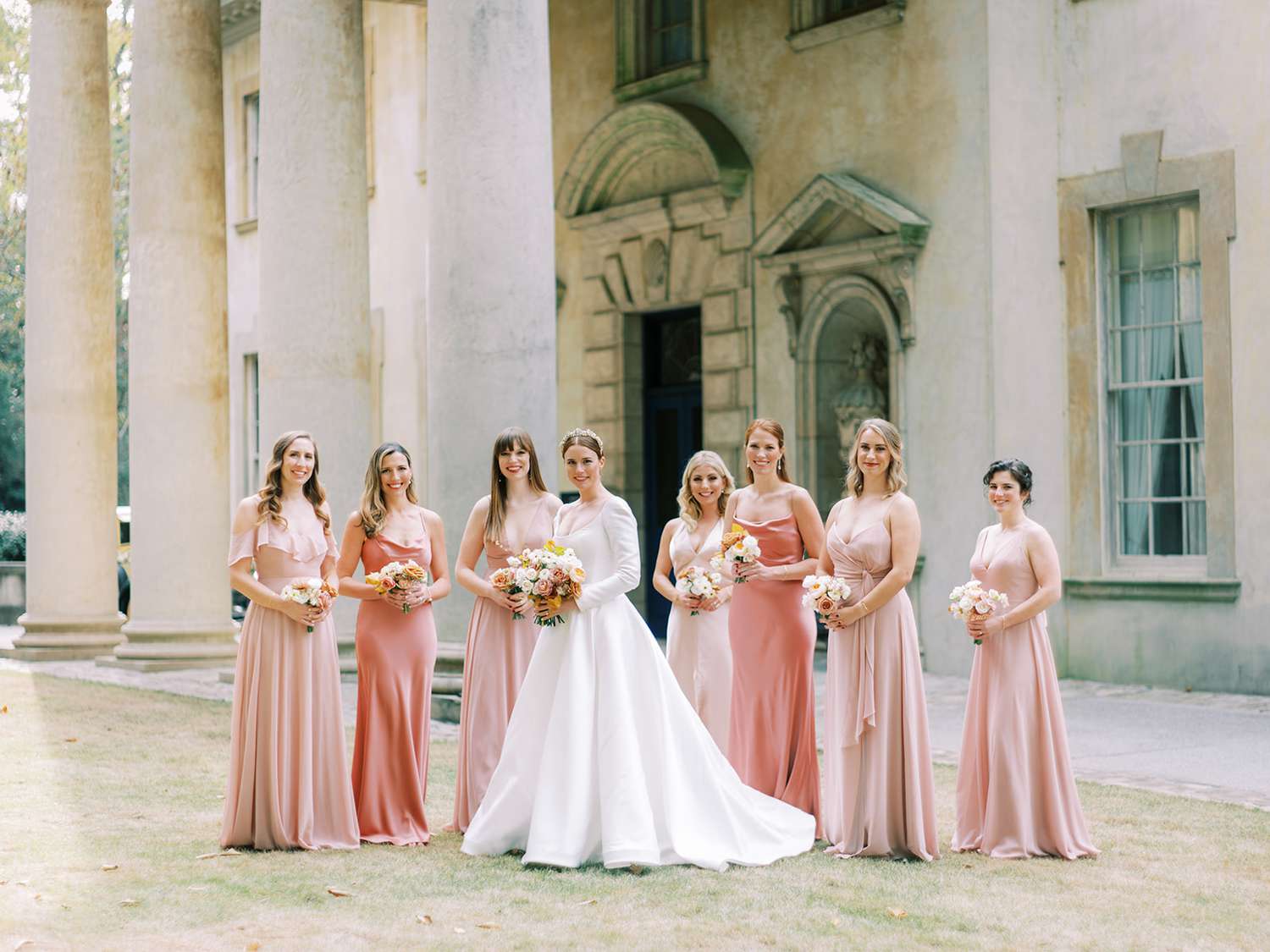 bride and bridesmaids wearing long pink dresses