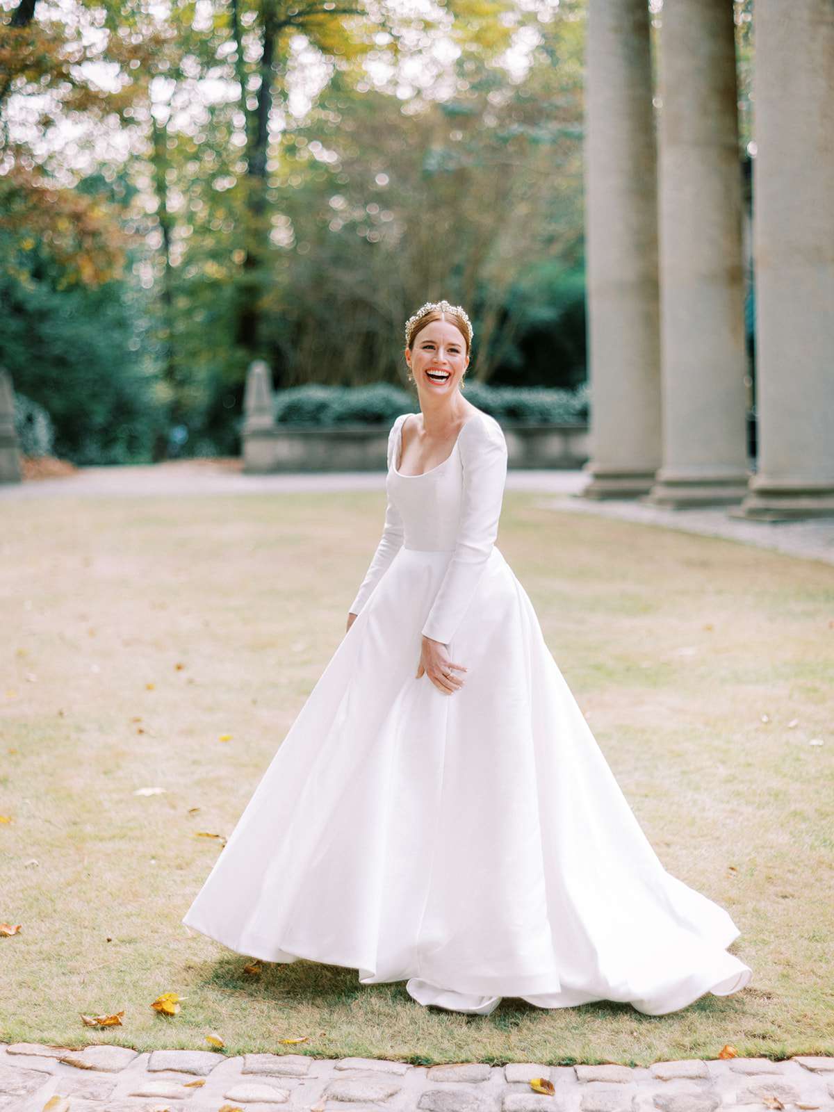 bride wearing long-sleeved wedding dress with full skirt