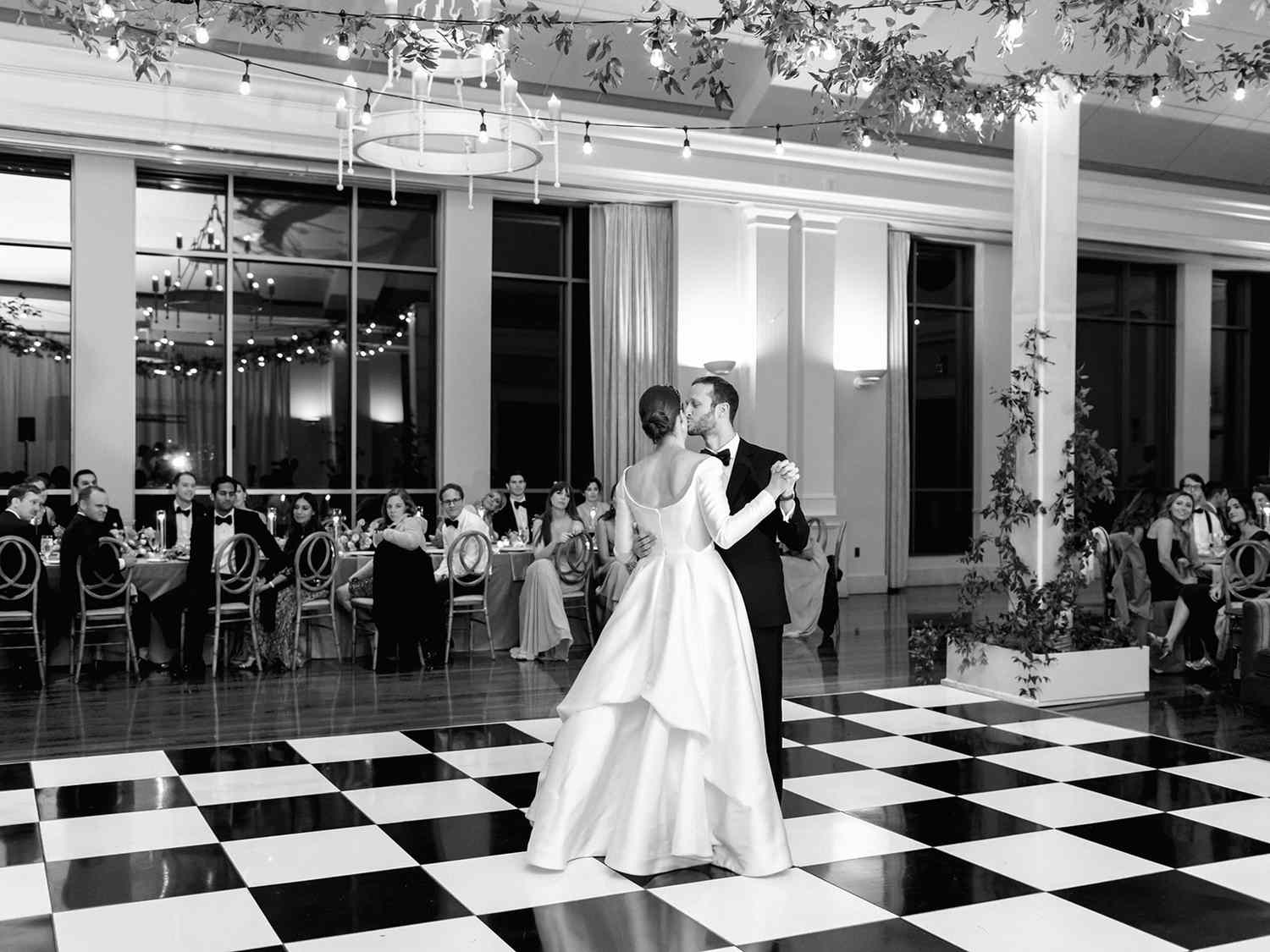 bride and groom sharing their first dance on checked dance floor