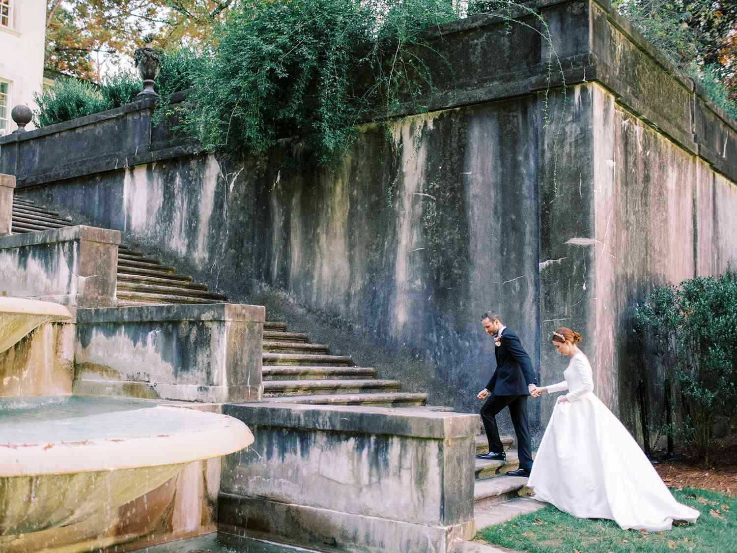 bride and groom walking up steps