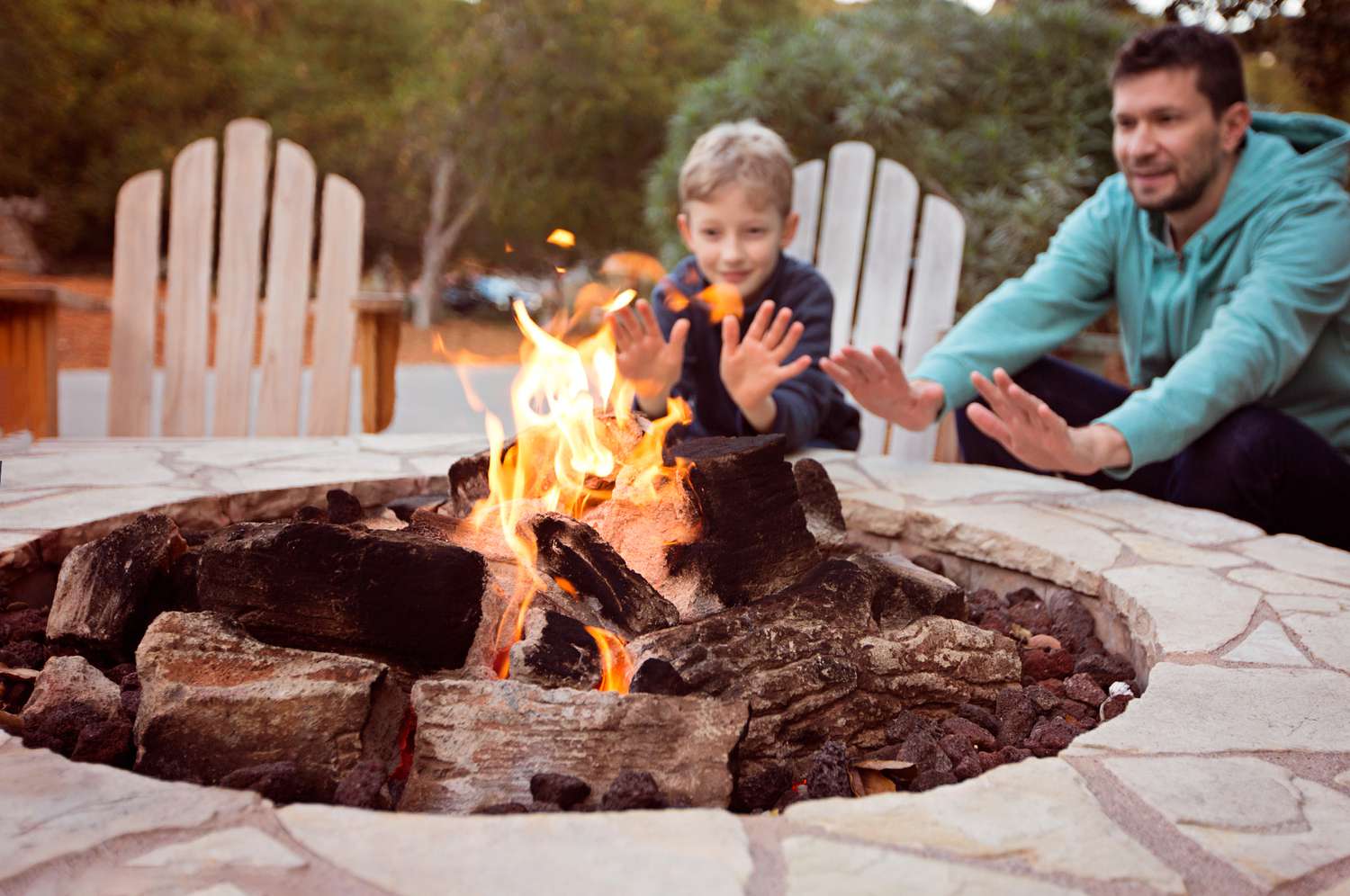 family enjoying outdoor fire pit
