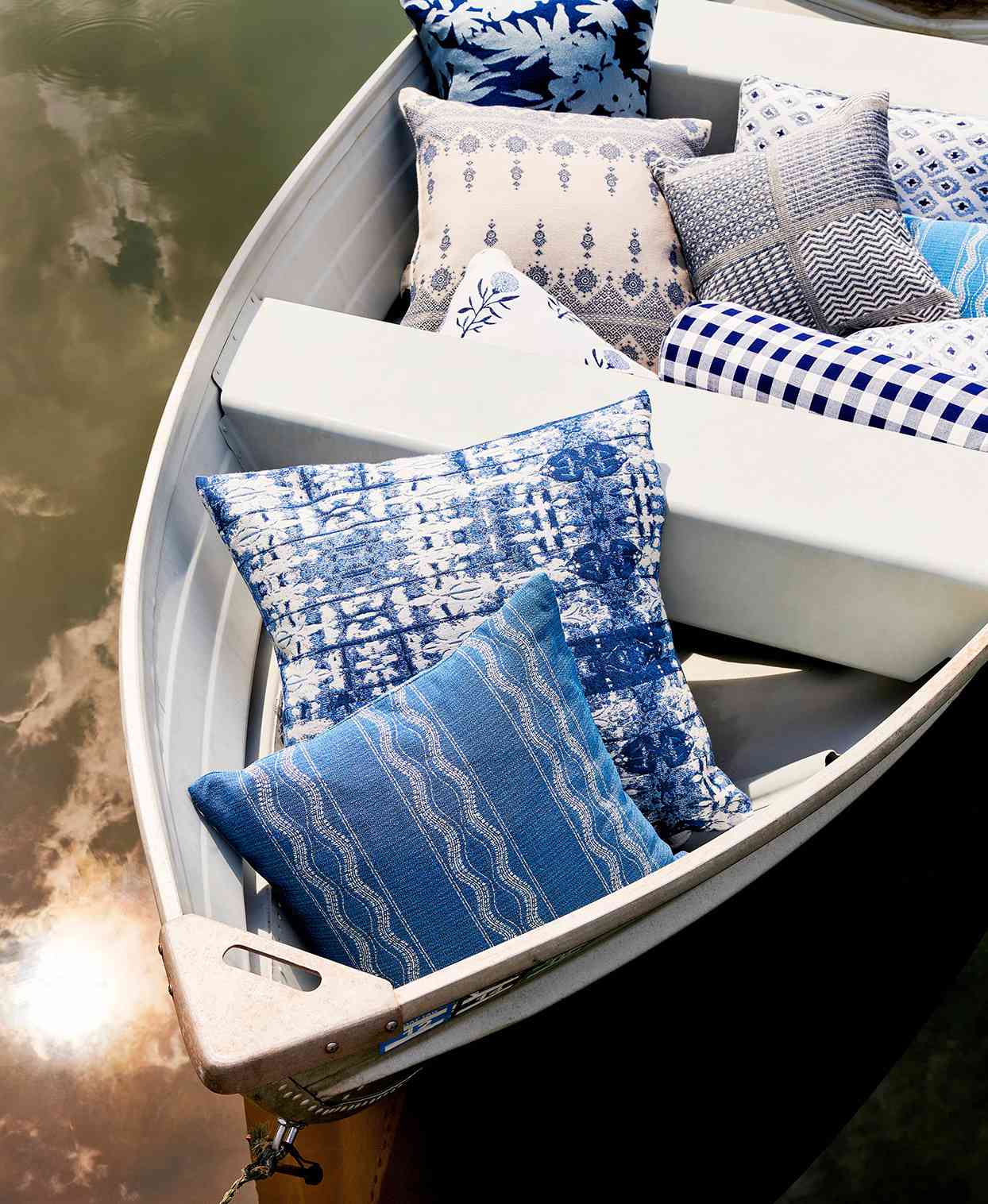 blue and white throw pillow filled boat