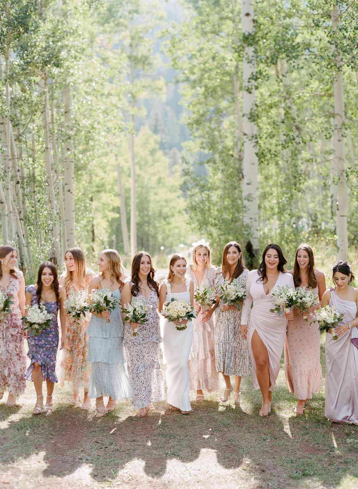 bride with bridesmaids wearing mismatched floral dresses