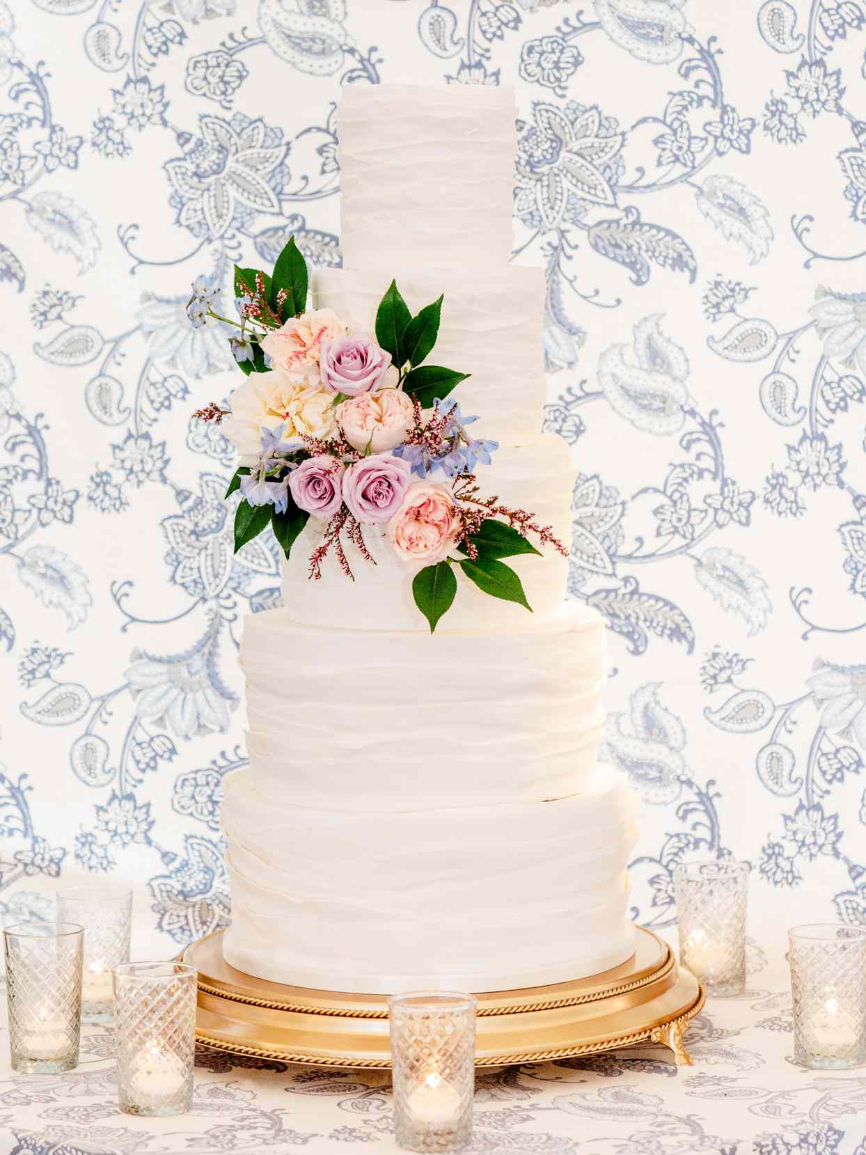 simple five tiered wedding cake embellished with fresh flowers