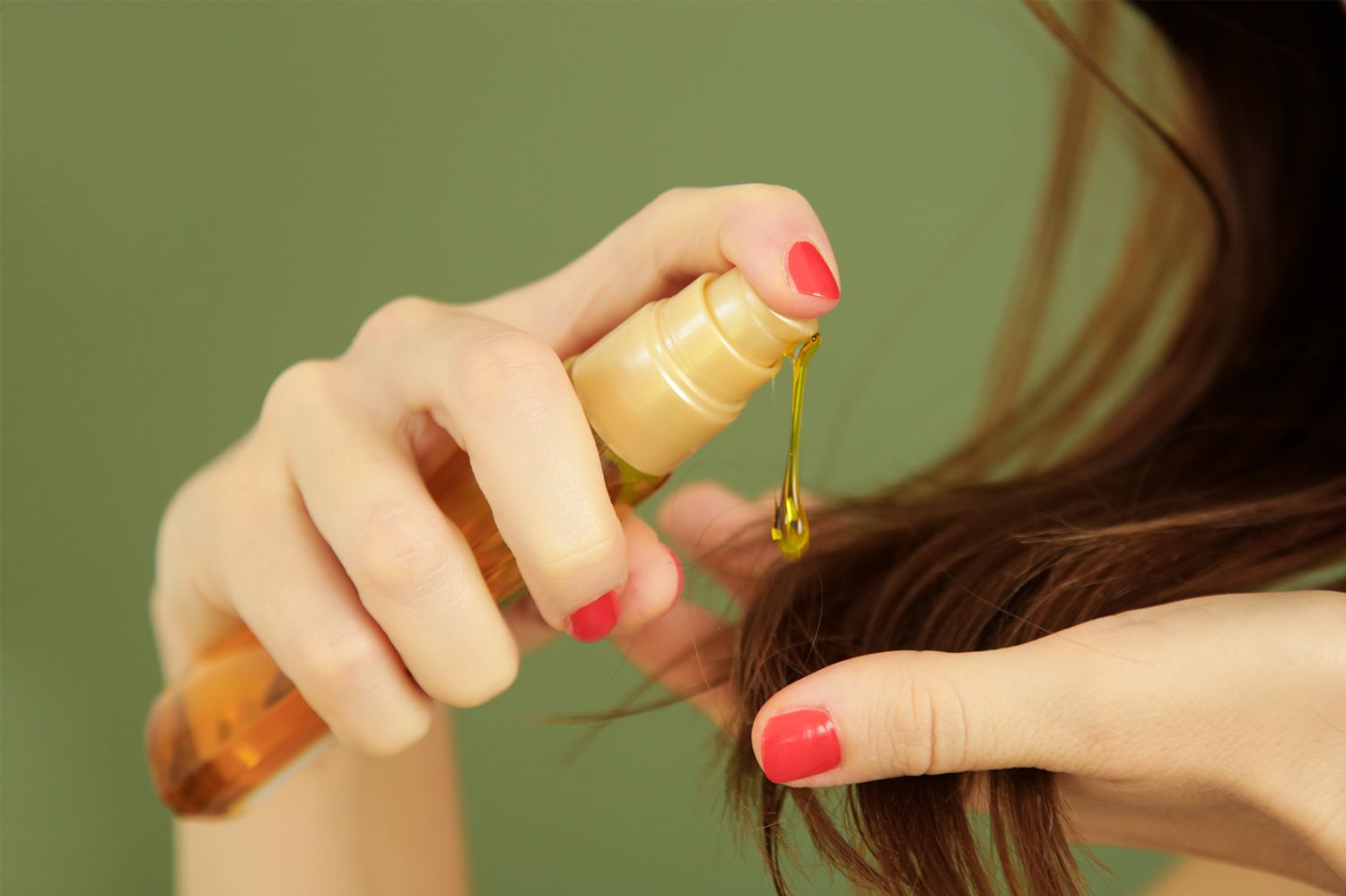Woman using hair serum on ends