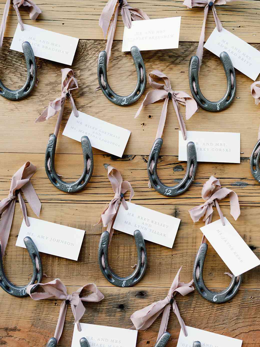 wedding escort card horseshoes tied with ribbons