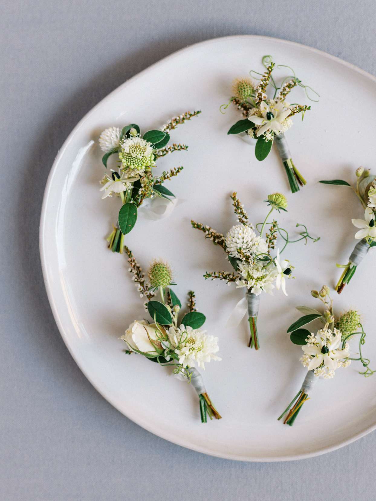 Boutonnieres on plate for wedding