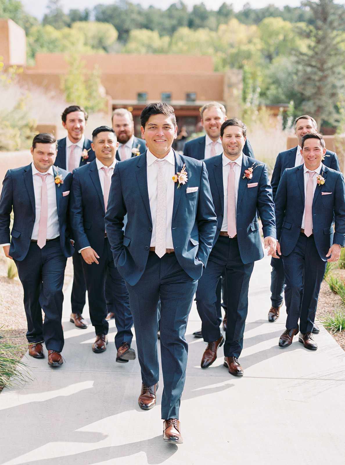 groom with groomsmen wearing slim-fit navy suits