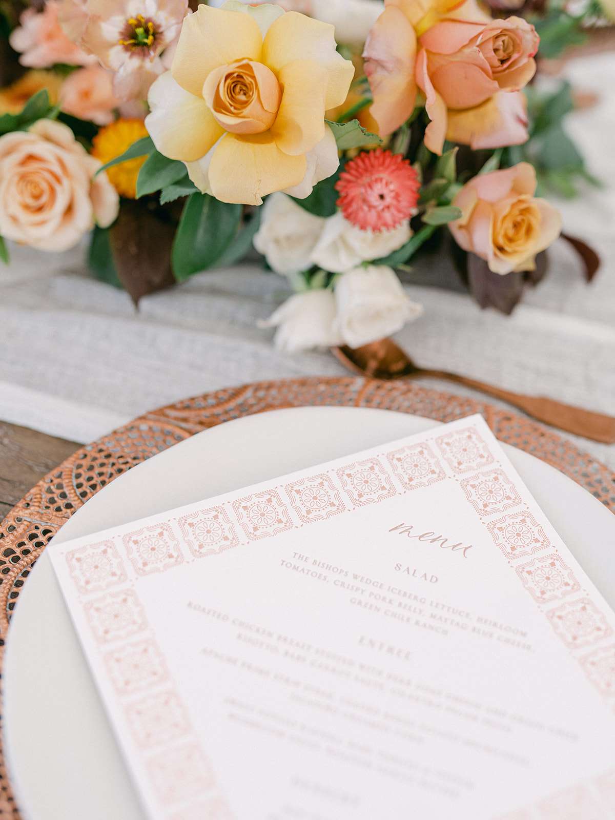 wedding reception place setting with natural chargers and tile-inspired menus