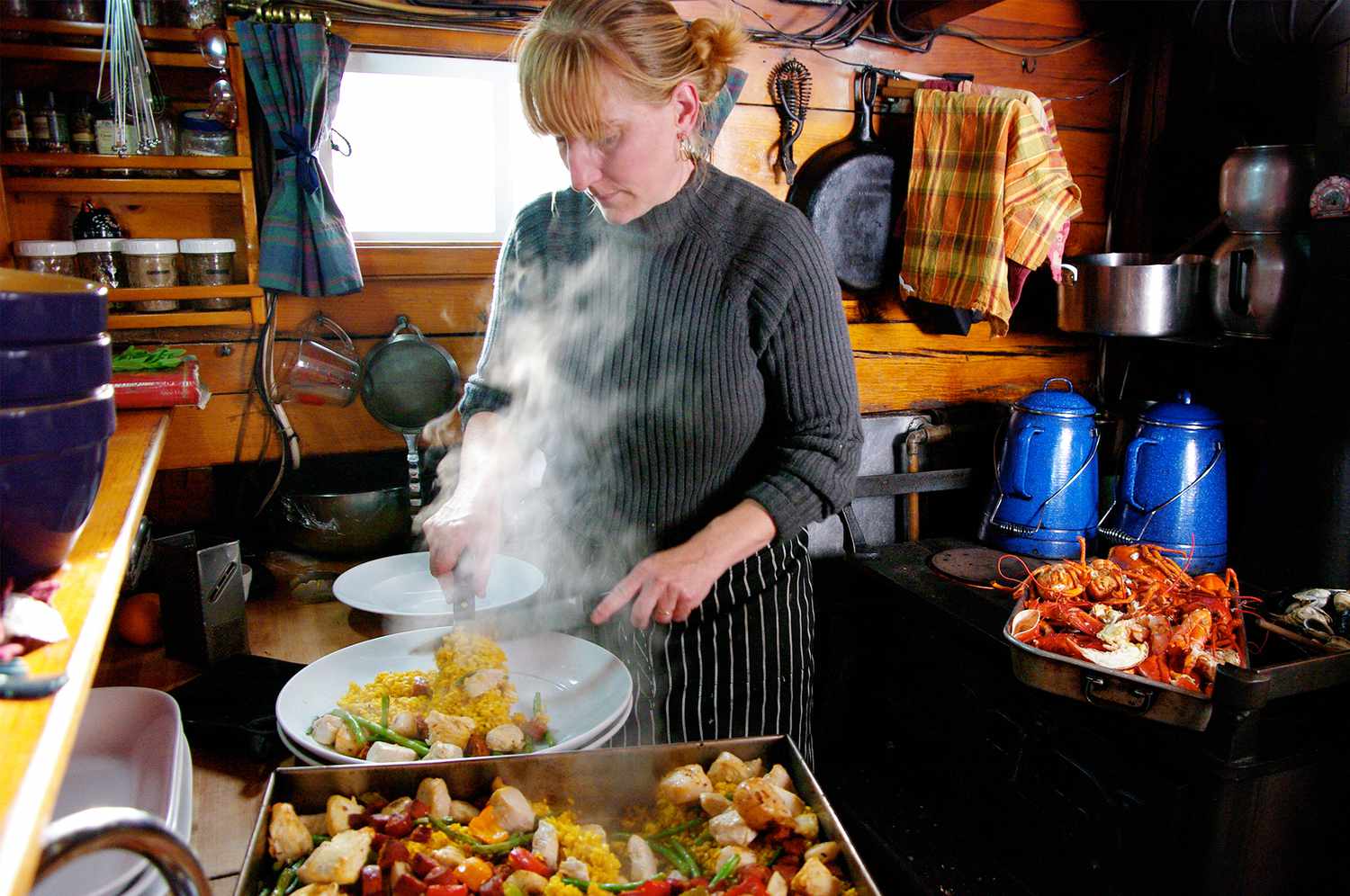 chef Annie Mahle cooking in a boat galley