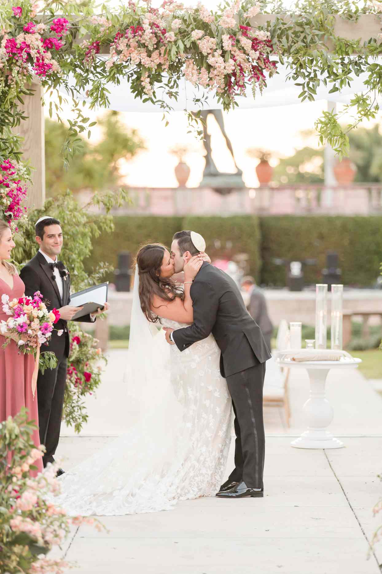 bride and groom kiss after wedding ceremony