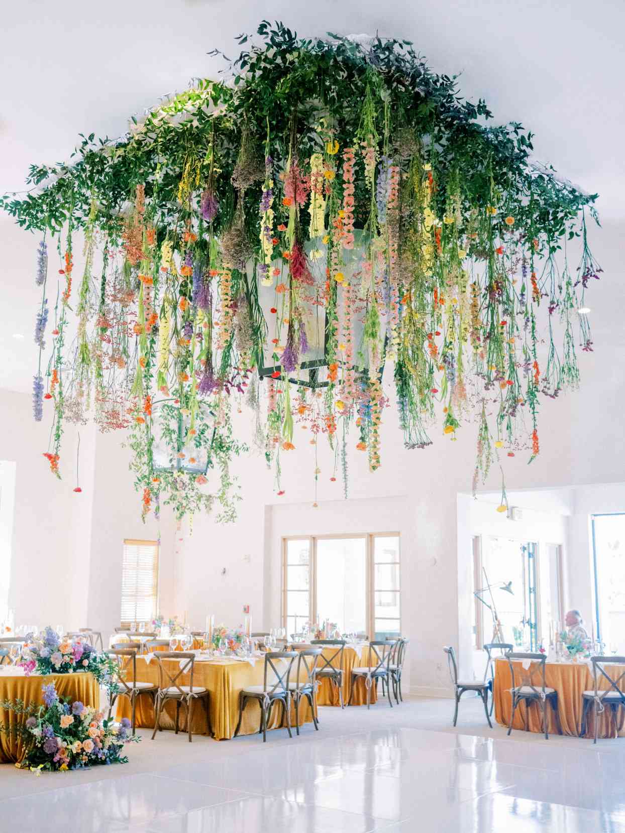 wedding reception setup with floral chandelier